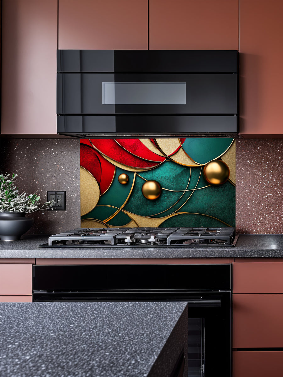 Tempered glass kitchen backsplash featuring a highly realistic 3D illusion of abstract overlapping geometric circles and waves in rich ruby red and emerald green with striking gold outlines and floating 3D metallic gold spheres, installed behind a modern stainless steel stove.