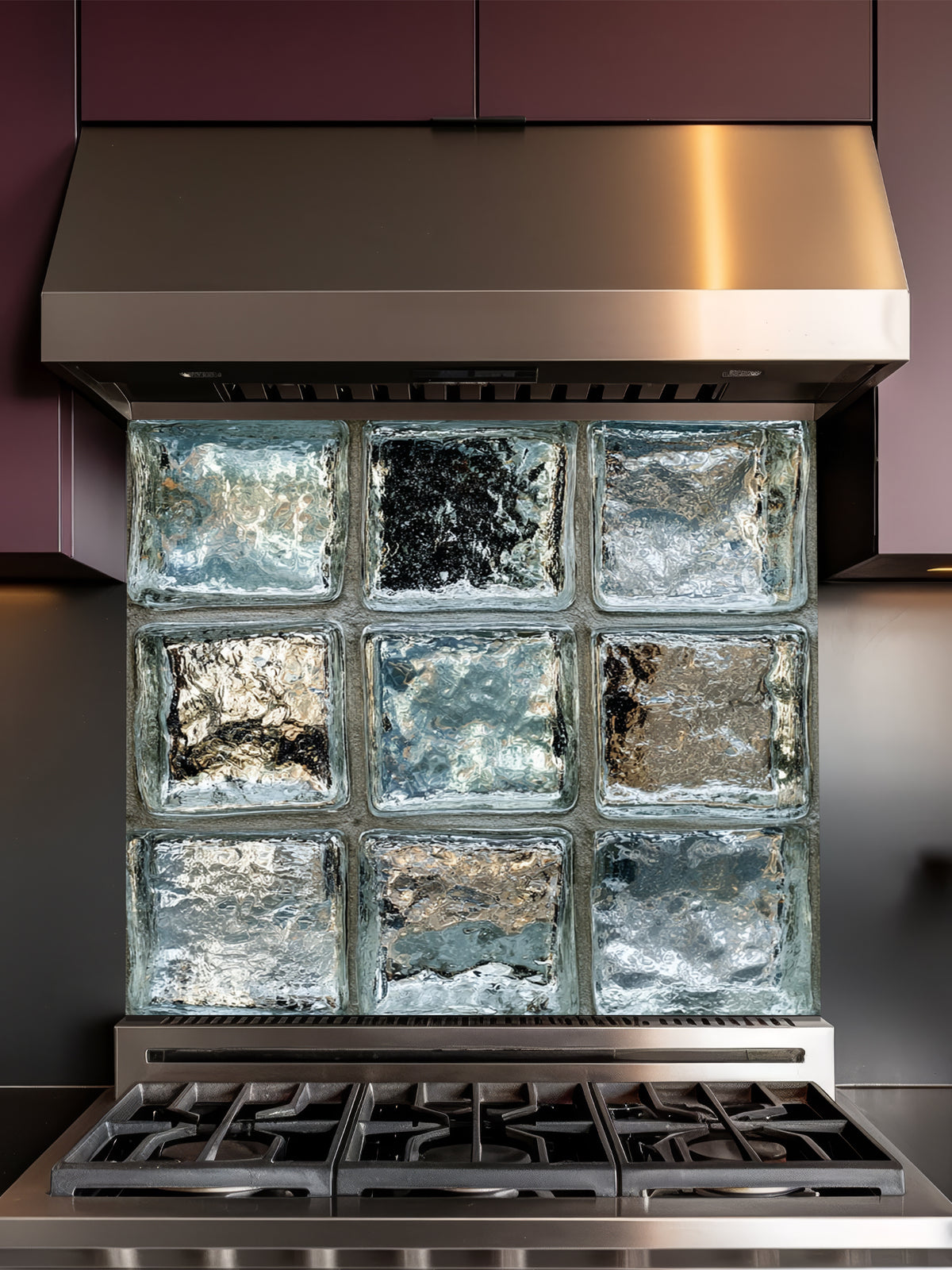 Tempered glass kitchen backsplash featuring a highly realistic 3D illusion of classic architectural clear glass blocks with authentic wavy, ice-like textures and sleek silver-grey reflections, installed behind a modern black stove.