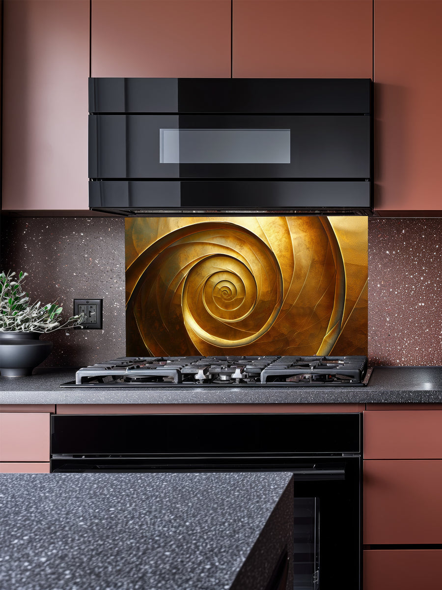 Tempered glass kitchen backsplash featuring a highly realistic 3D illusion of an abstract metallic golden spiral or vortex with deep shadows and glowing bronze highlights, installed behind a modern black stove.