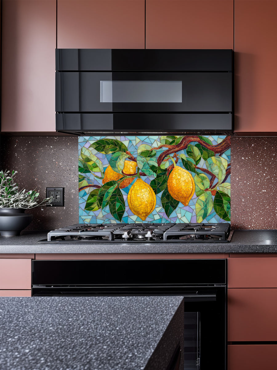 Tempered glass kitchen backsplash featuring a highly realistic 3D illusion of mosaic tile art showing bright yellow lemons and lush green leaves on a branch against a multi-toned light blue and teal mosaic background, installed behind a modern black stove.