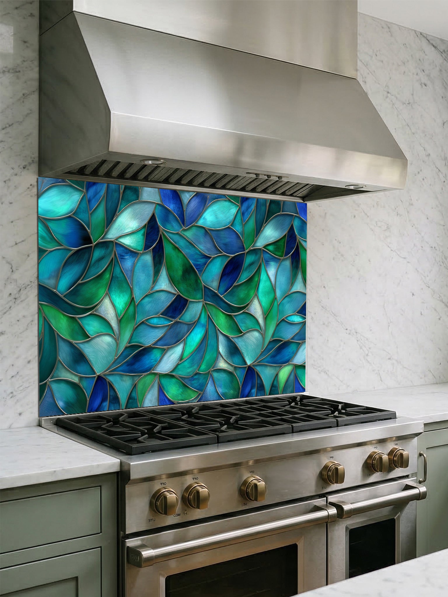 Tempered glass kitchen backsplash featuring a vibrant botanical stained glass effect with overlapping leaves in shades of teal, blue, and emerald green, installed behind a modern stainless steel stove.