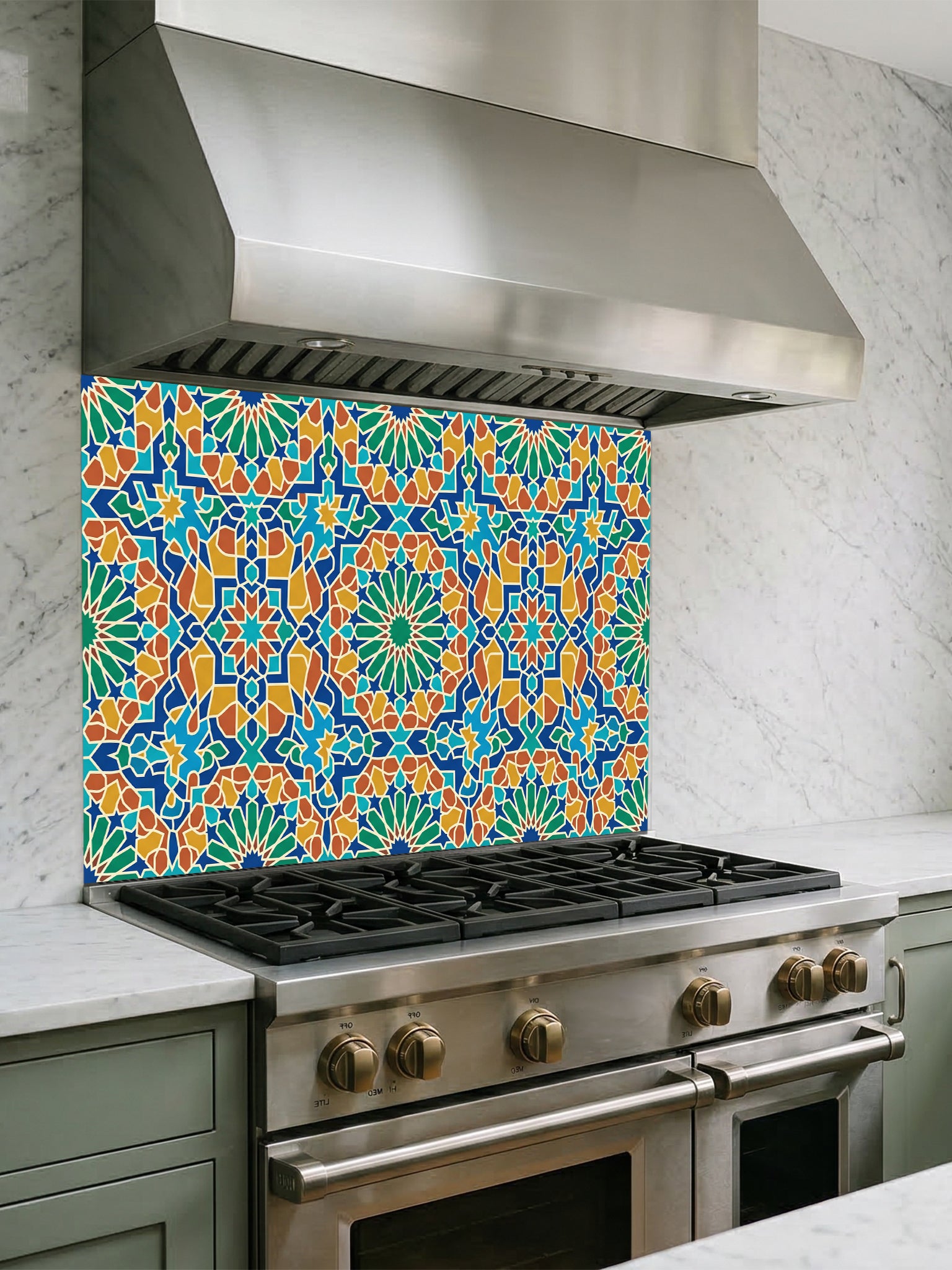 Stainless steel range hood above a gas stove with a colorful geometric patterned backsplash.