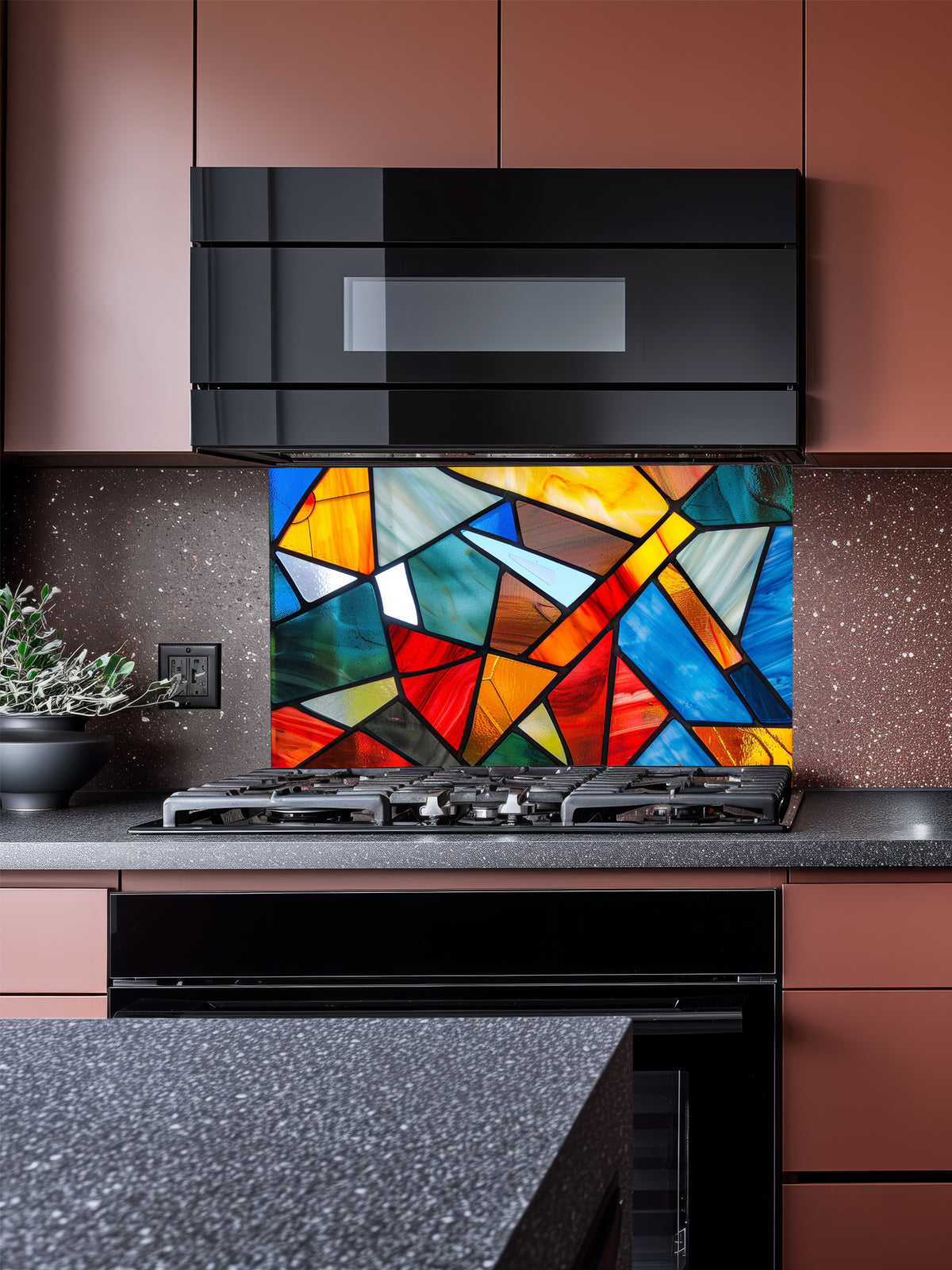 Tempered glass kitchen backsplash featuring a highly realistic illusion of abstract geometric stained glass with asymmetrical shards in vibrant, luminous shades of red, blue, yellow, and teal outlined by dark faux lead lines, installed behind a modern black stove.