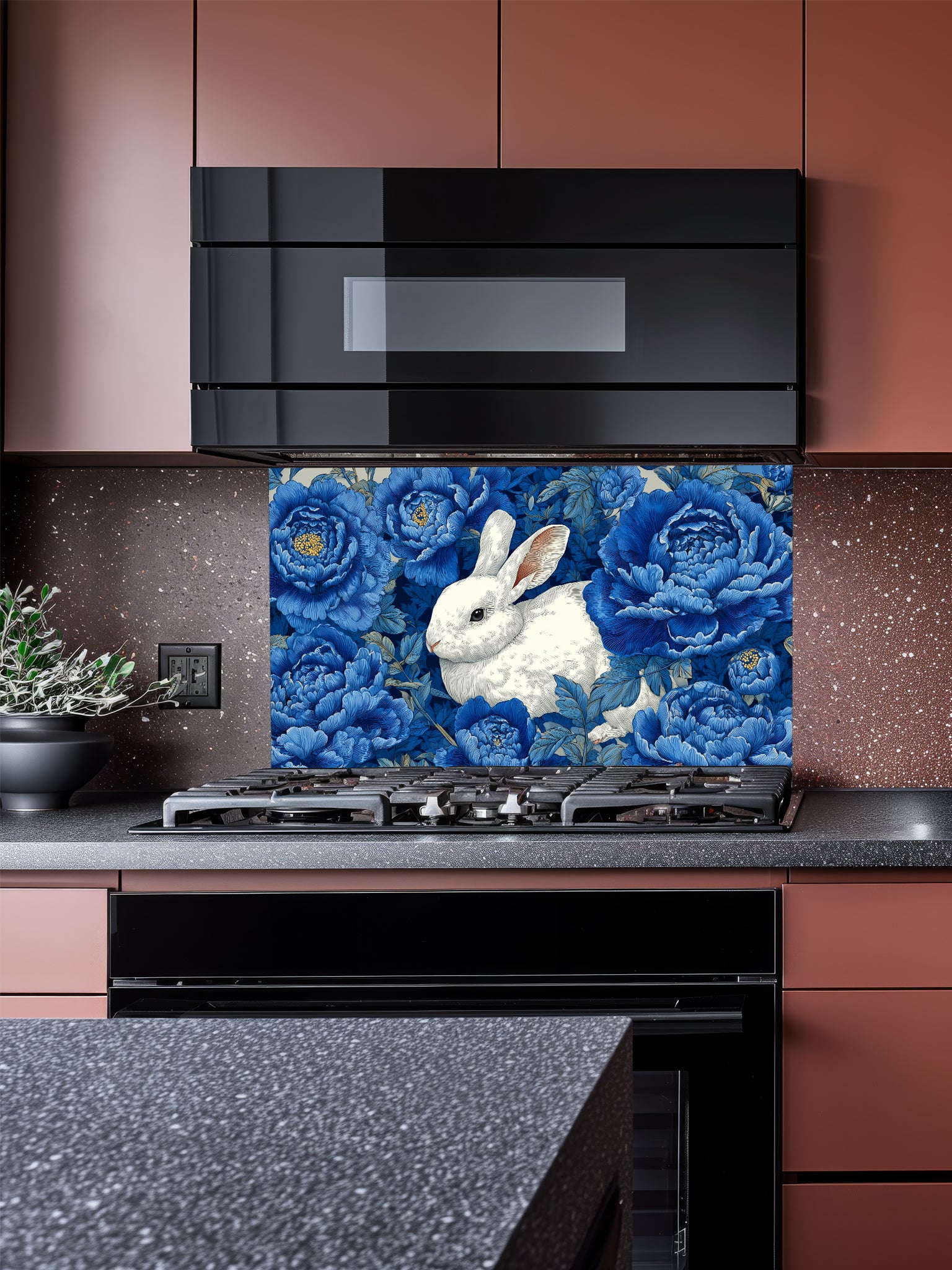 Vintage style illustration of a white rabbit sitting among large deep blue peony flowers, UV printed on a smooth tempered glass kitchen backsplash, installed behind a modern stove.