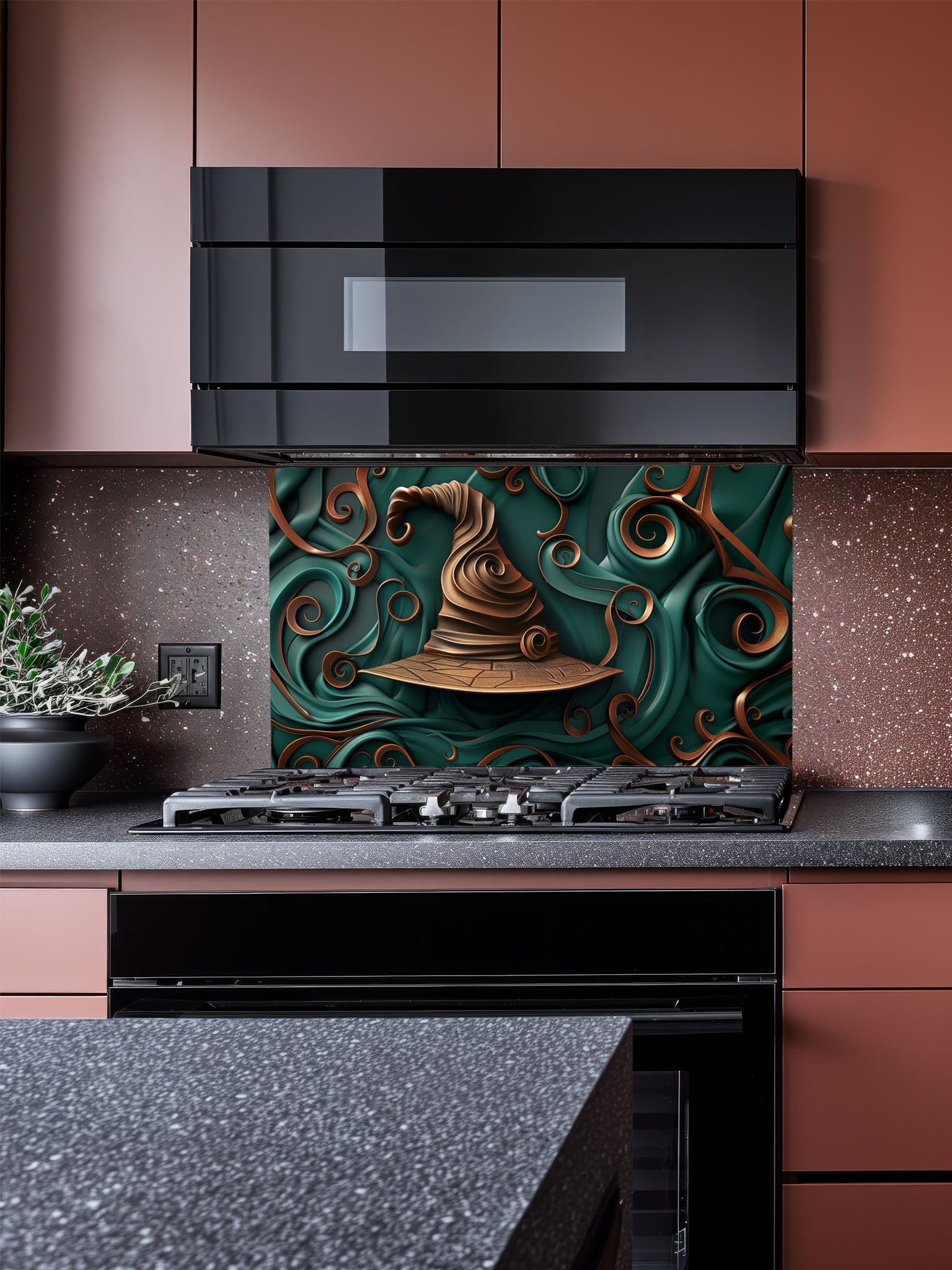 Tempered glass kitchen backsplash featuring a highly realistic 3D illusion of a sculpted, crooked bronze witch hat surrounded by heavy, flowing emerald green and copper ribbon-like swirls, installed behind a modern black stove.