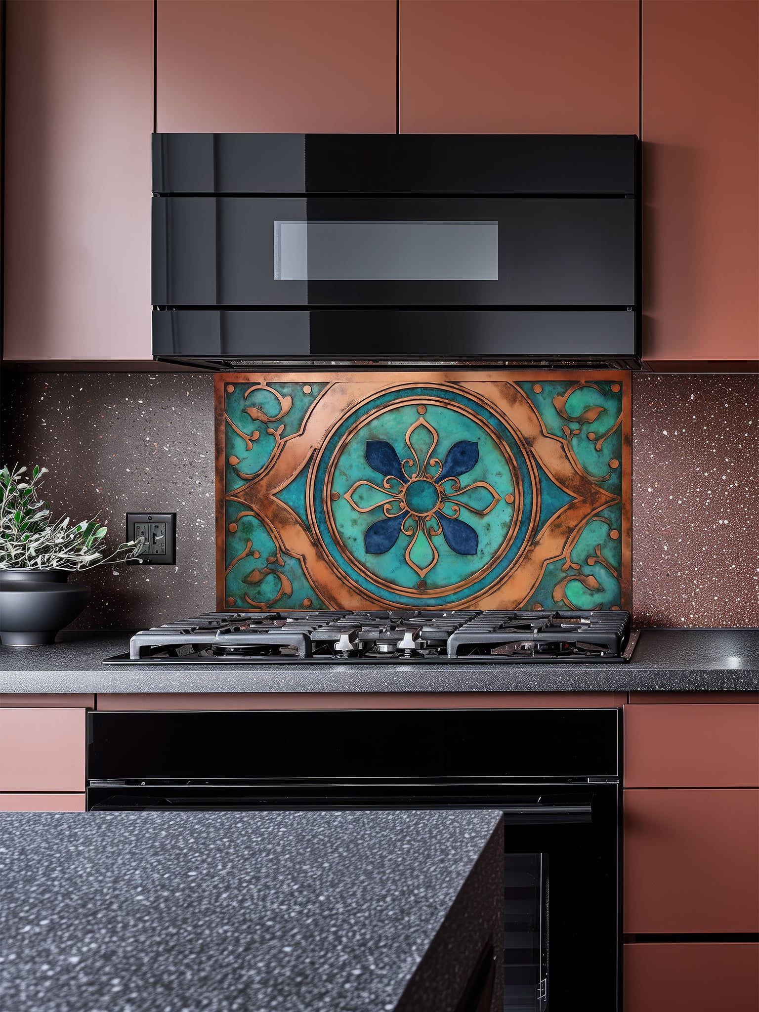 Tempered glass kitchen backsplash featuring a highly realistic 3D faux metal design of an ornate Moroccan floral mandala in oxidized copper with rich teal patina accents, installed behind a modern stainless steel stove.