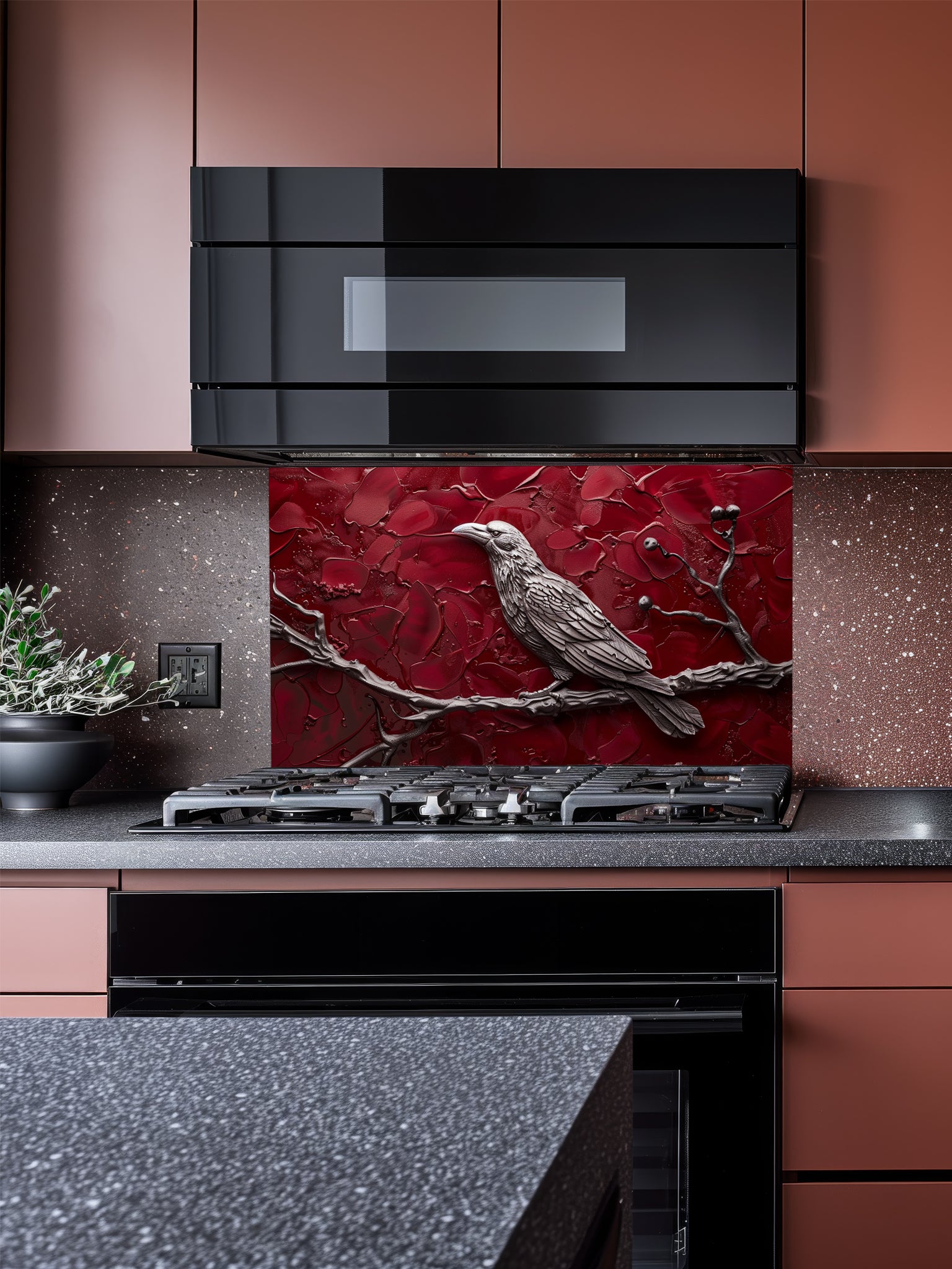 Tempered glass kitchen backsplash featuring a highly realistic 3D illusion of a sculpted metallic raven perched on a branch with berries against a heavily textured, thick impasto crimson red background, installed behind a modern black stove.