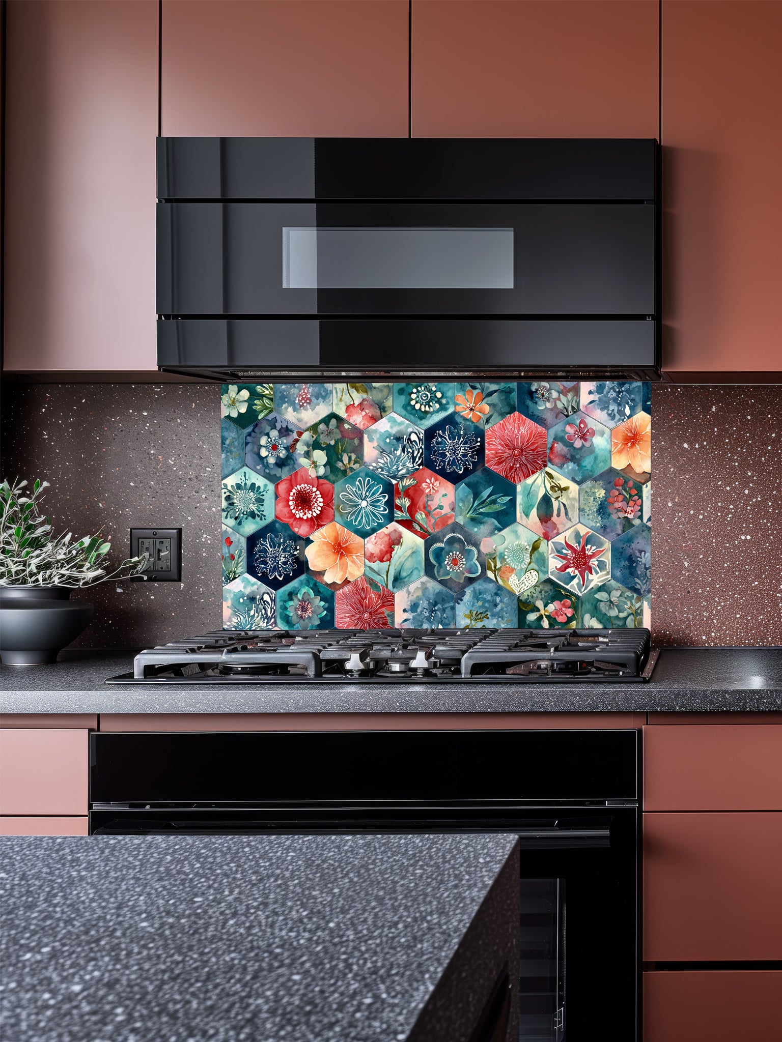 Tempered glass kitchen backsplash featuring a highly realistic illusion of geometric hexagon tiles showcasing delicate, hand-painted style watercolor floral patterns in navy blue, teal, coral red, and peach, installed behind a modern black stove.