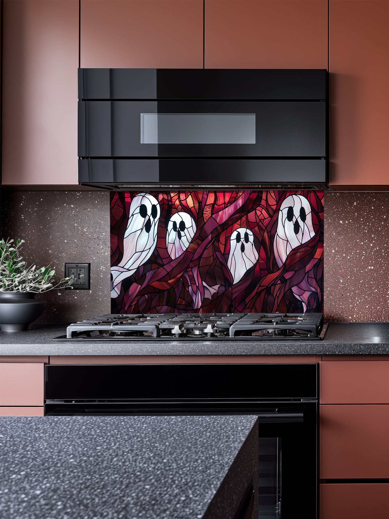 Tempered glass kitchen backsplash featuring a highly realistic 3D illusion of macabre stained glass art showing spooky white ghosts floating among twisted dark red and purple haunted forest branches, installed behind a modern stainless steel stove.