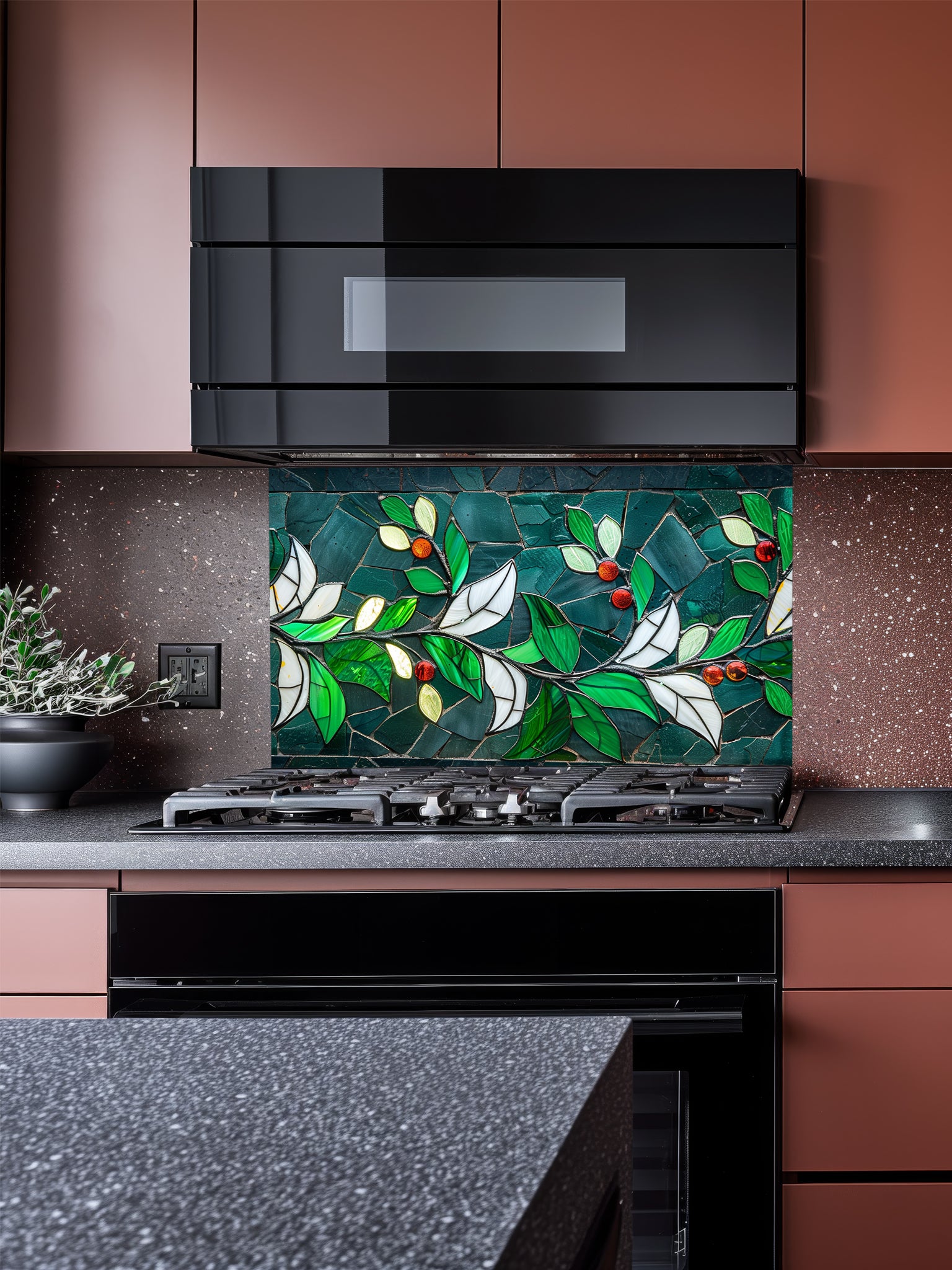 Tempered glass kitchen backsplash featuring a highly realistic 3D illusion of stained glass and mosaic art showing a graceful branch with vibrant emerald green and white leaves and glowing red berries against a dark teal background, installed behind a modern black stove.