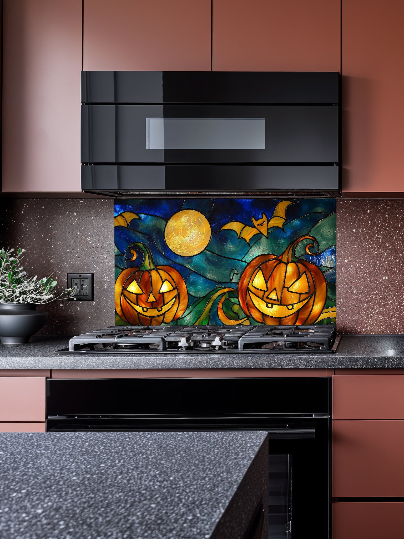 Kitchen with a decorative backsplash featuring pumpkins and a moon.