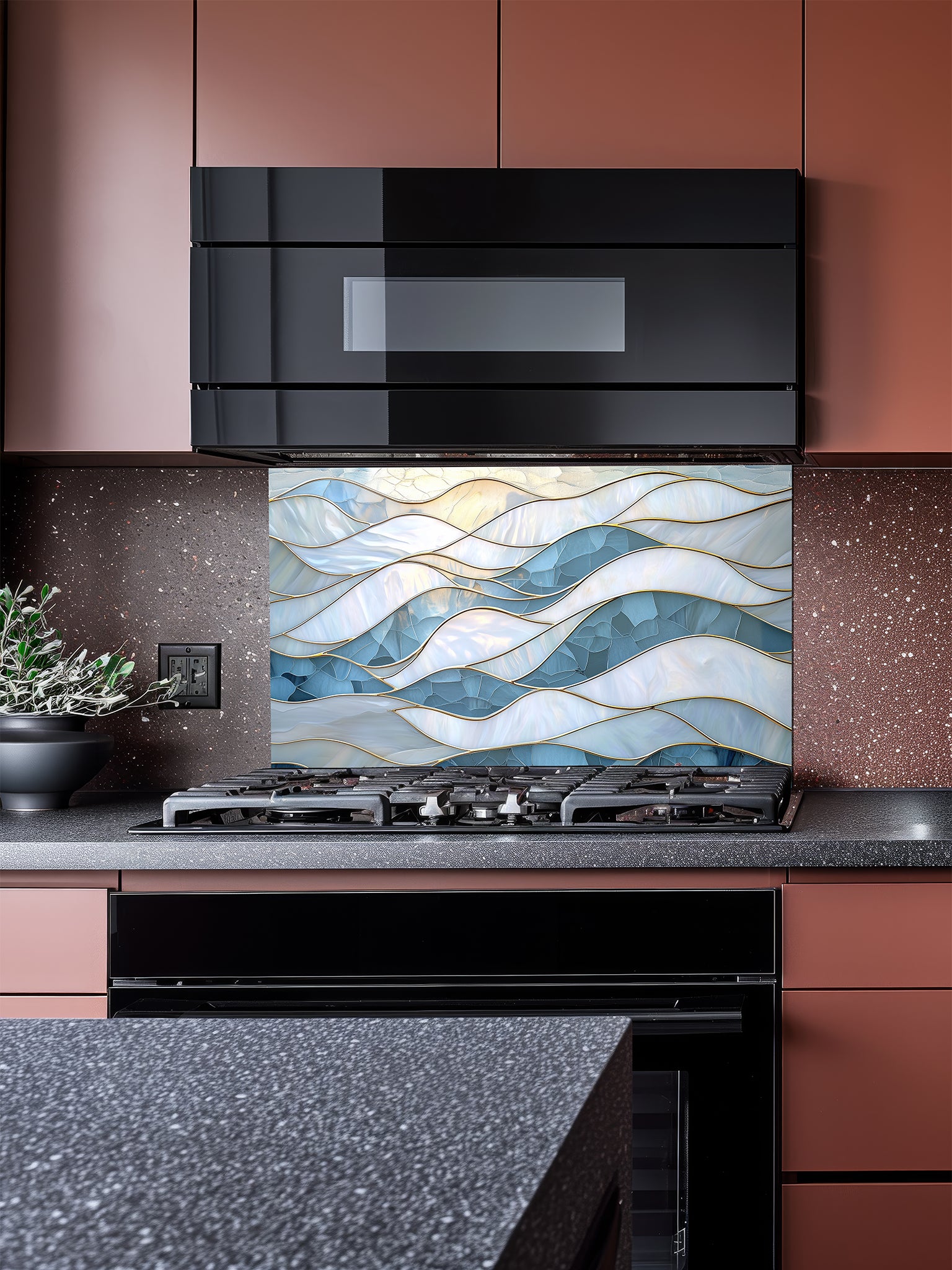 Tempered glass kitchen backsplash featuring a serene faux stained glass design of layered, flowing waves in icy blue and pearlescent white, separated by elegant gold outlines, installed behind a modern stainless steel stove.