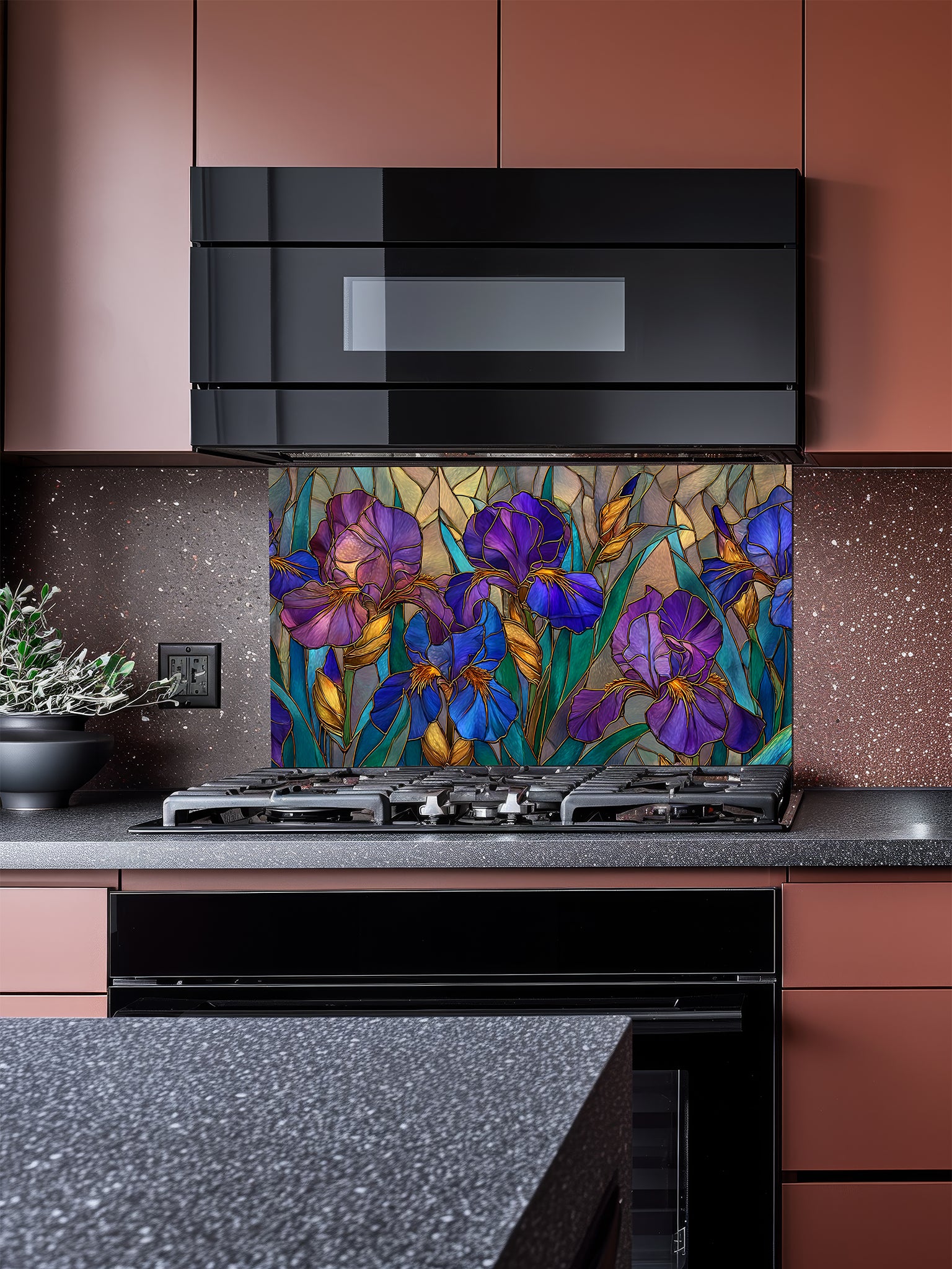 Tempered glass kitchen backsplash featuring an elegant faux stained glass design of vibrant purple and blue Iris flowers with green leaves and elegant gold outlines, installed behind a modern stainless steel stove.