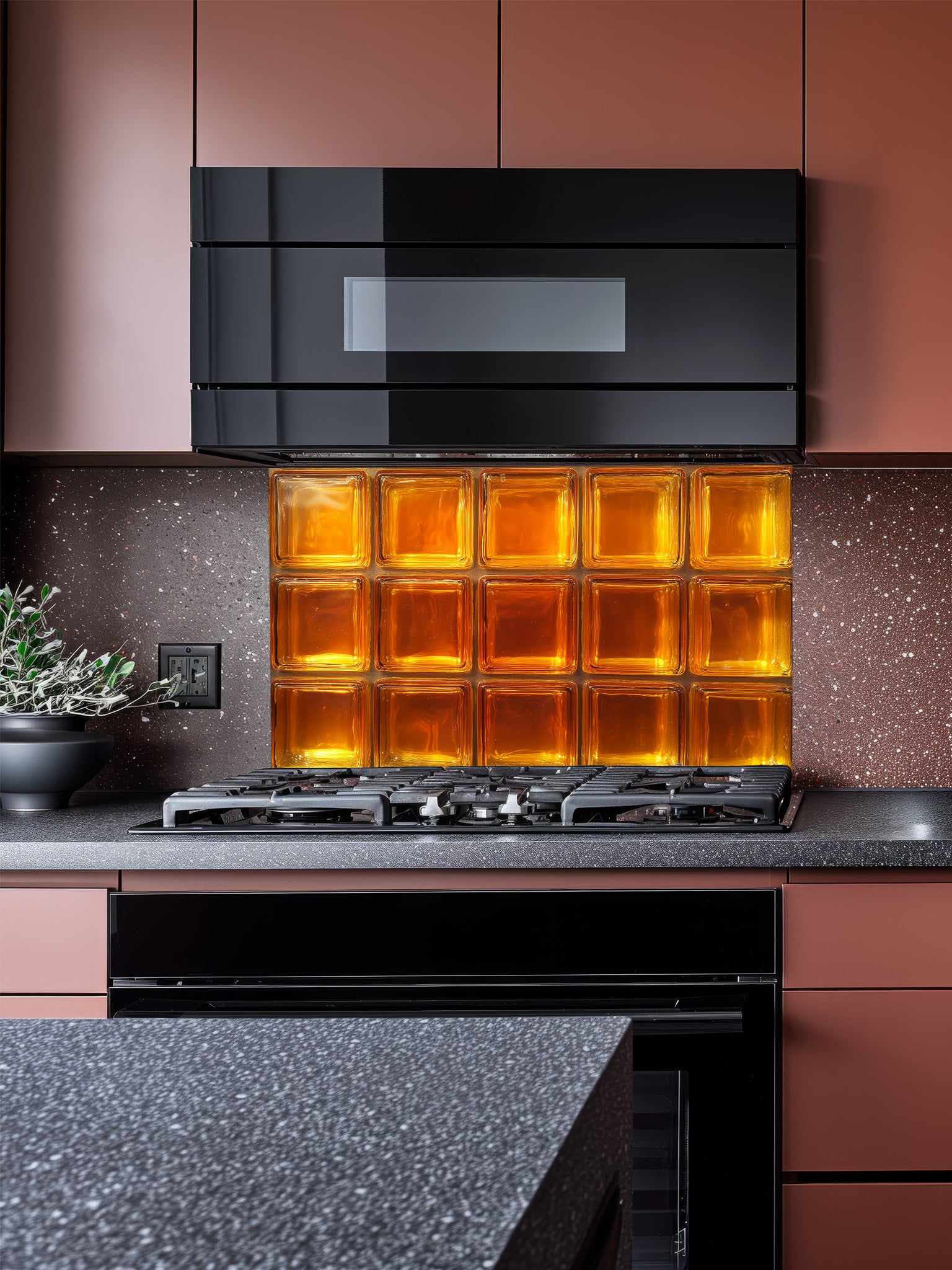 A retro-style kitchen featuring a tempered glass backsplash with a highly realistic faux amber glass block design, giving a warm glowing illusion behind a modern black stove.