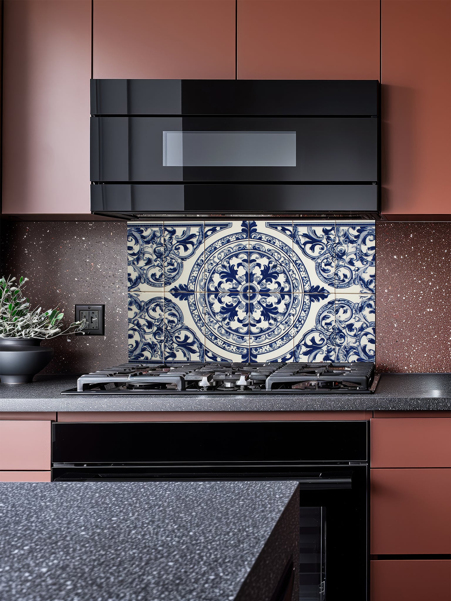 Tempered glass kitchen backsplash featuring a traditional Mediterranean blue and white Azulejo faux tile design with an ornate central floral mandala pattern, installed behind a modern stainless steel stove.