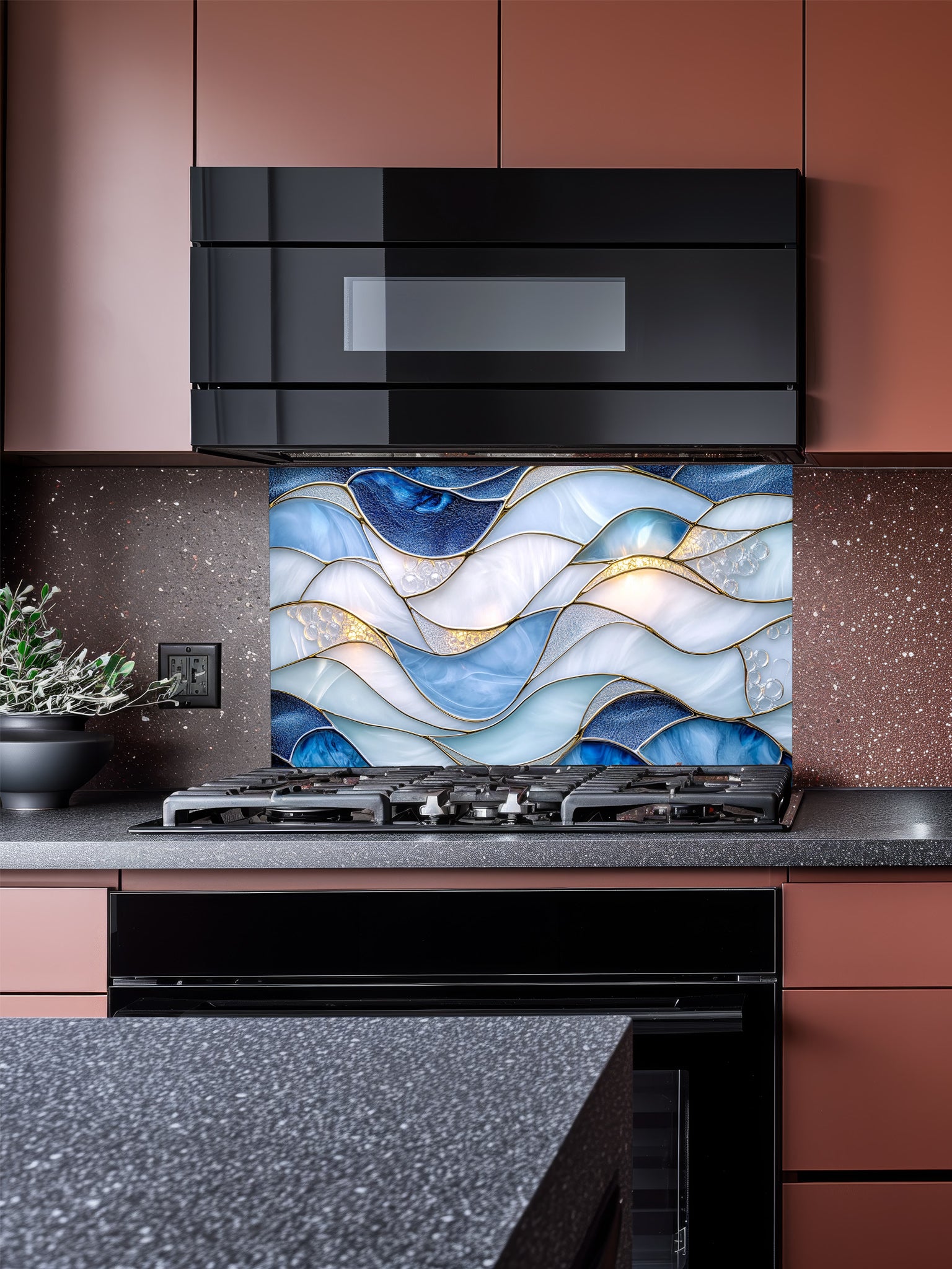 A modern kitchen featuring a tempered glass backsplash with a luxurious abstract fluid art design of blue and white waves with 3D-effect gold veins, installed behind a stainless steel stove.