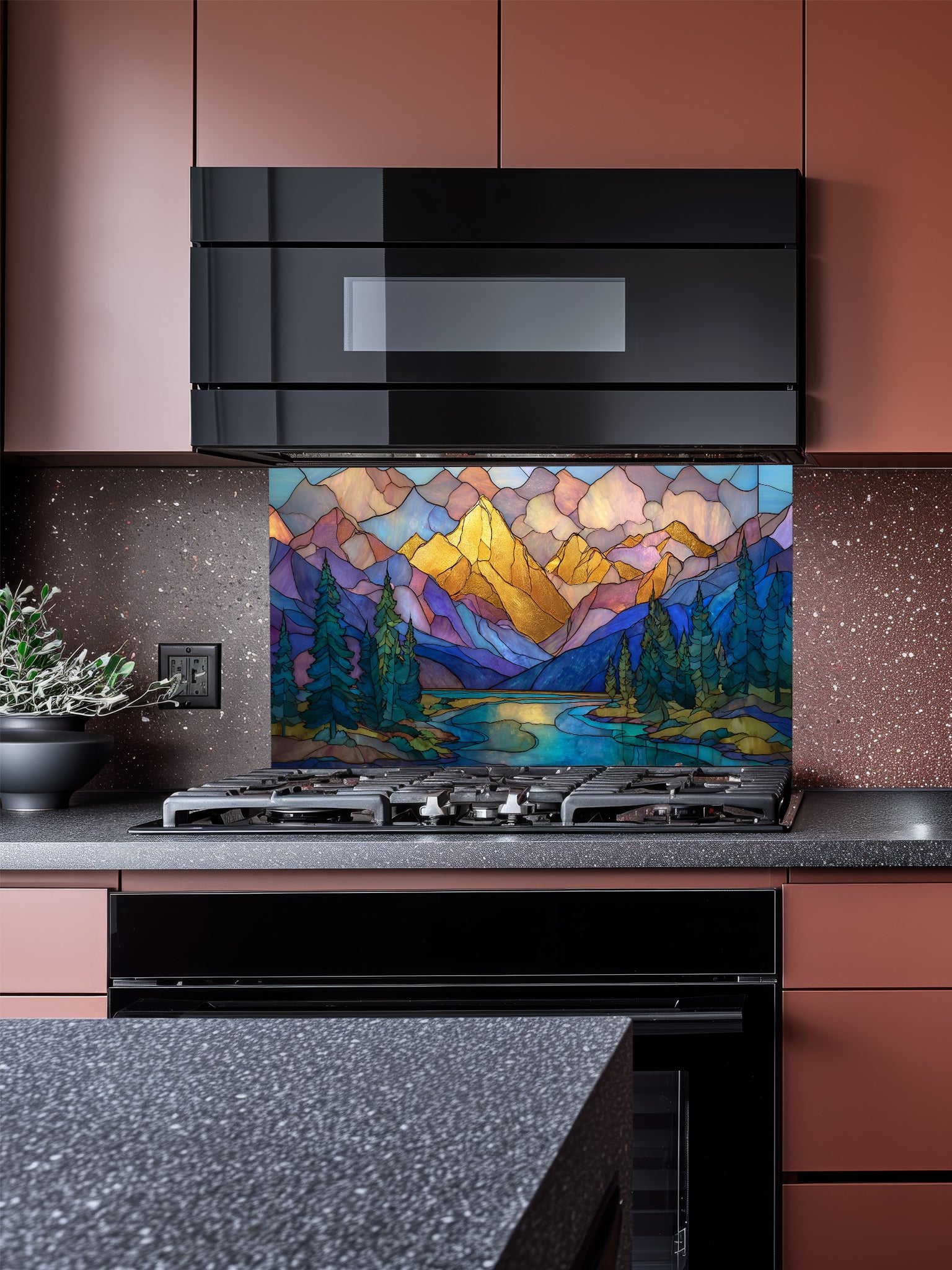 A cozy kitchen featuring a tempered glass backsplash with a beautiful stained glass effect landscape, showcasing majestic mountains, pine trees, and a winding river at sunset, installed behind a modern stainless steel stove.