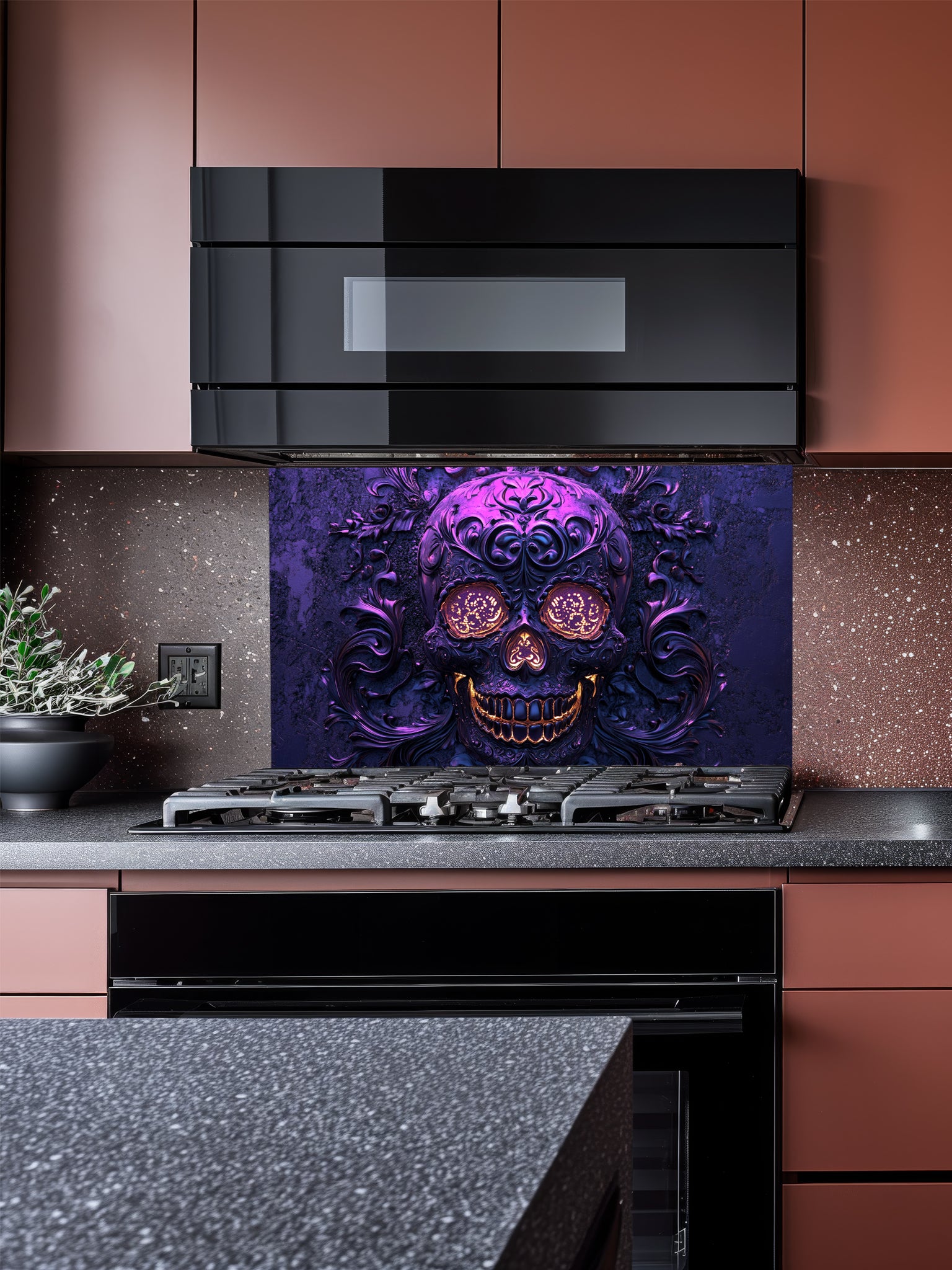 Tempered glass kitchen backsplash featuring a highly realistic 3D illusion of an embossed, intricately carved gothic skull with glowing gold eyes and teeth, surrounded by dark purple baroque filigree swirls, installed behind a modern black stove.