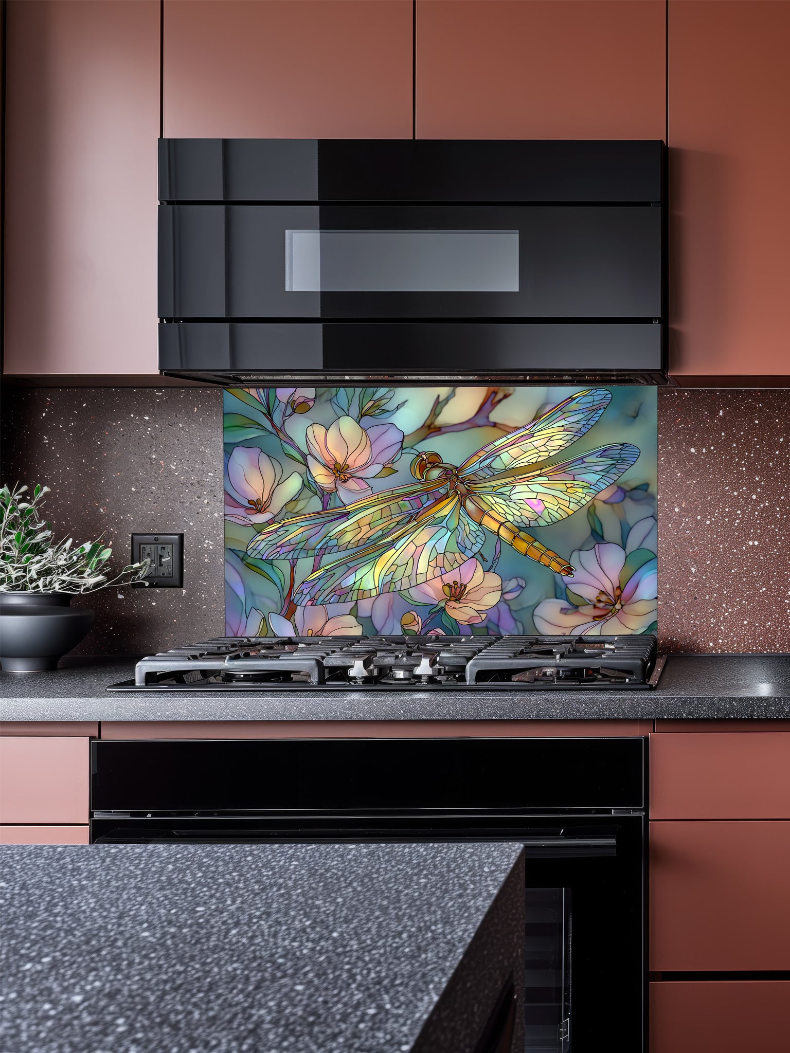 Tempered glass kitchen backsplash featuring a highly realistic 3D illusion of Art Nouveau stained glass showing an elegant dragonfly with iridescent translucent wings resting among soft pastel pink and mint green blooming flowers, installed behind a modern stainless steel stove.