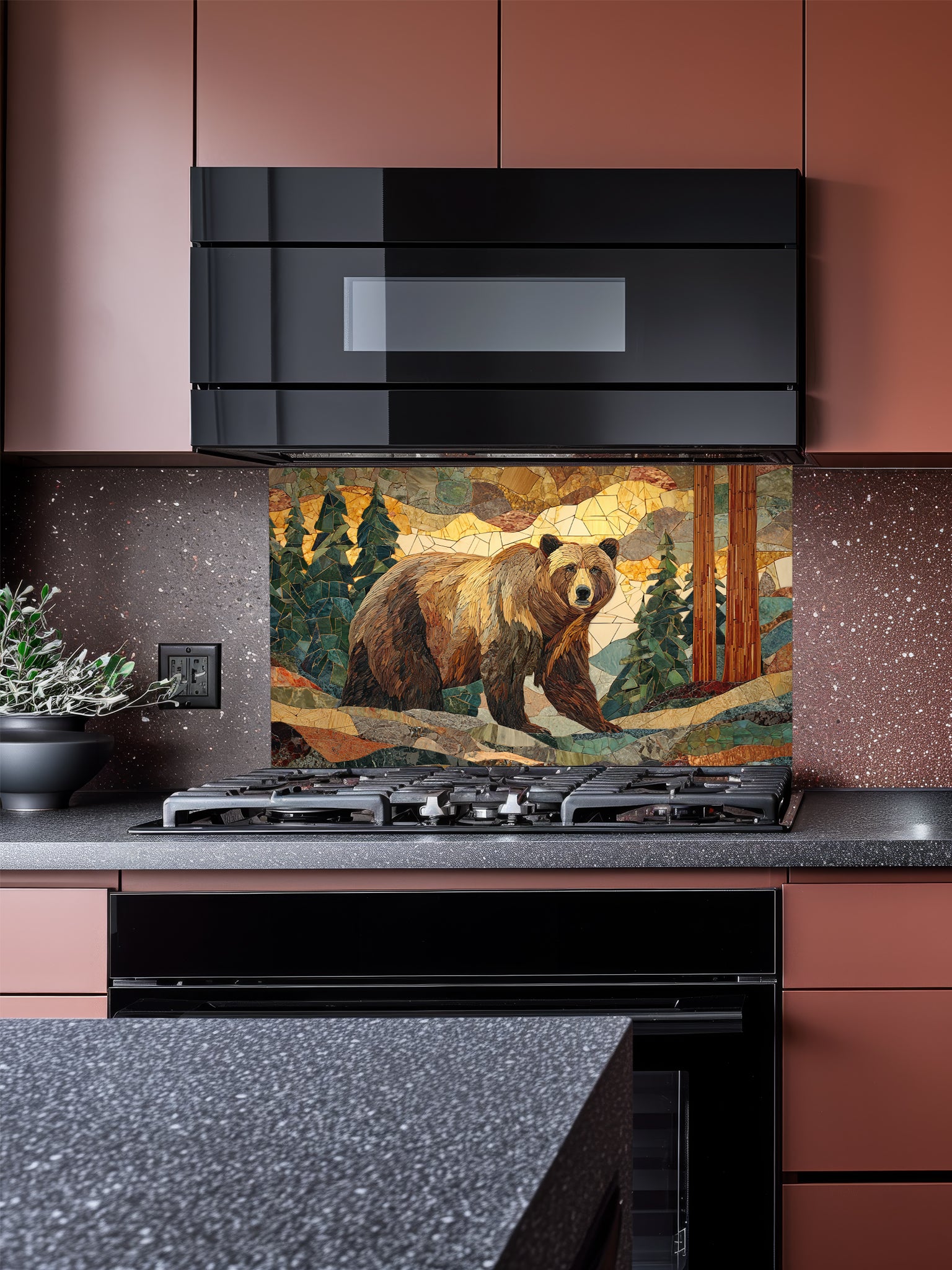 Tempered glass kitchen backsplash featuring a highly realistic 3D illusion of a rugged stone mosaic artwork showing a majestic brown bear walking through a forest of pine trees and mountains in earthy brown, green, and golden tones, installed behind a modern black stove.