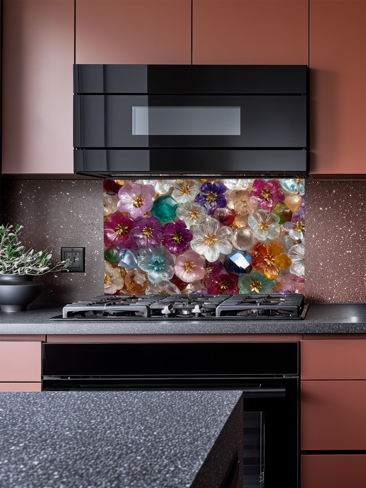 Tempered glass kitchen backsplash featuring a highly realistic 3D illusion of a dense, sparkling mosaic made of translucent glass flowers and crystal gems in vibrant jewel tones of purple, ruby, sapphire, emerald, and gold, installed behind a modern black stove.