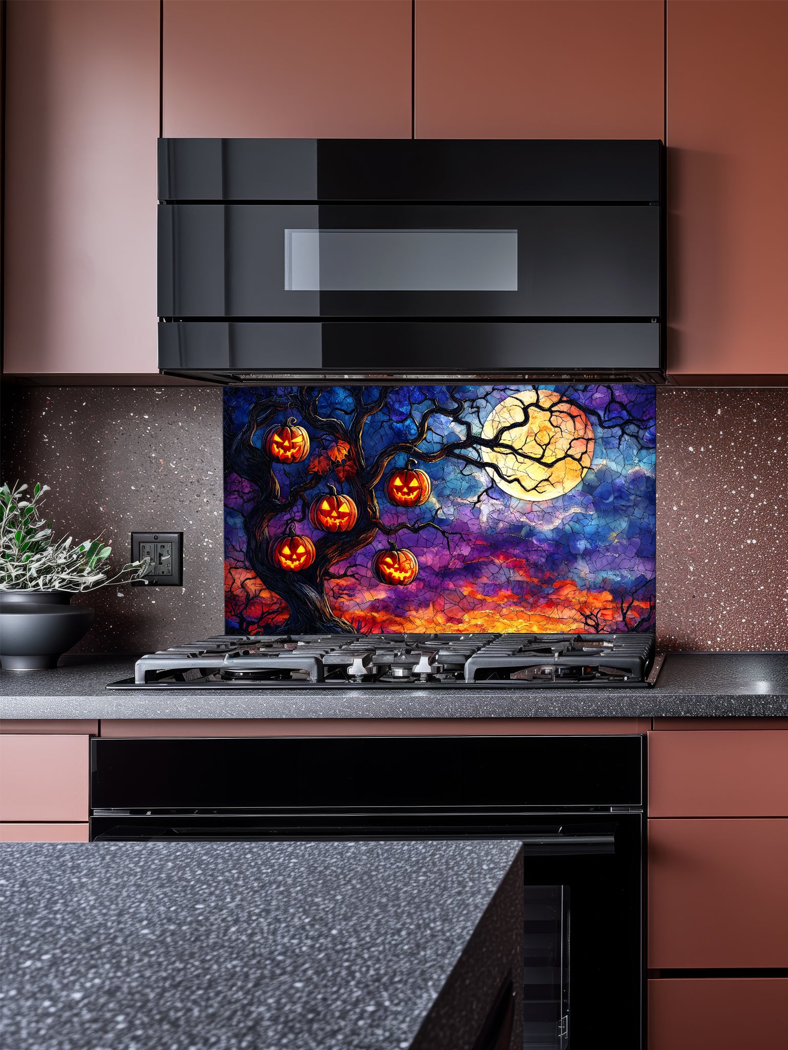 Kitchen with a decorative backsplash featuring pumpkins and a moon.