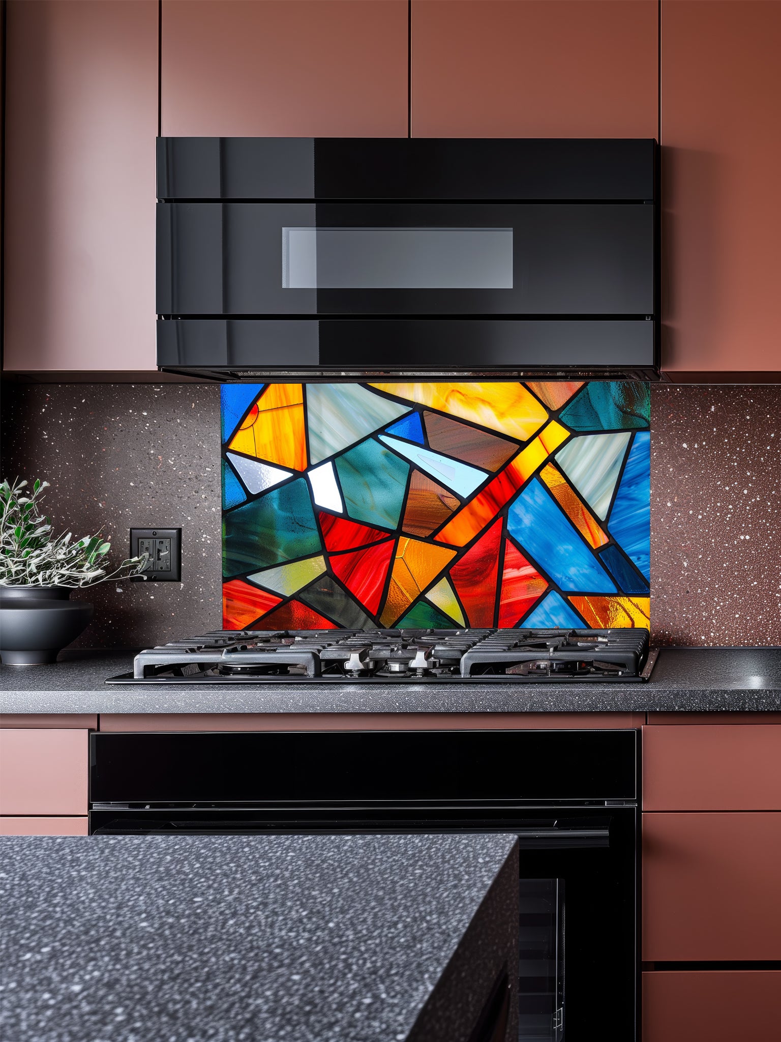 Tempered glass kitchen backsplash featuring a highly realistic illusion of abstract geometric stained glass with asymmetrical shards in vibrant, luminous shades of red, blue, yellow, and teal outlined by dark faux lead lines, installed behind a modern black stove.