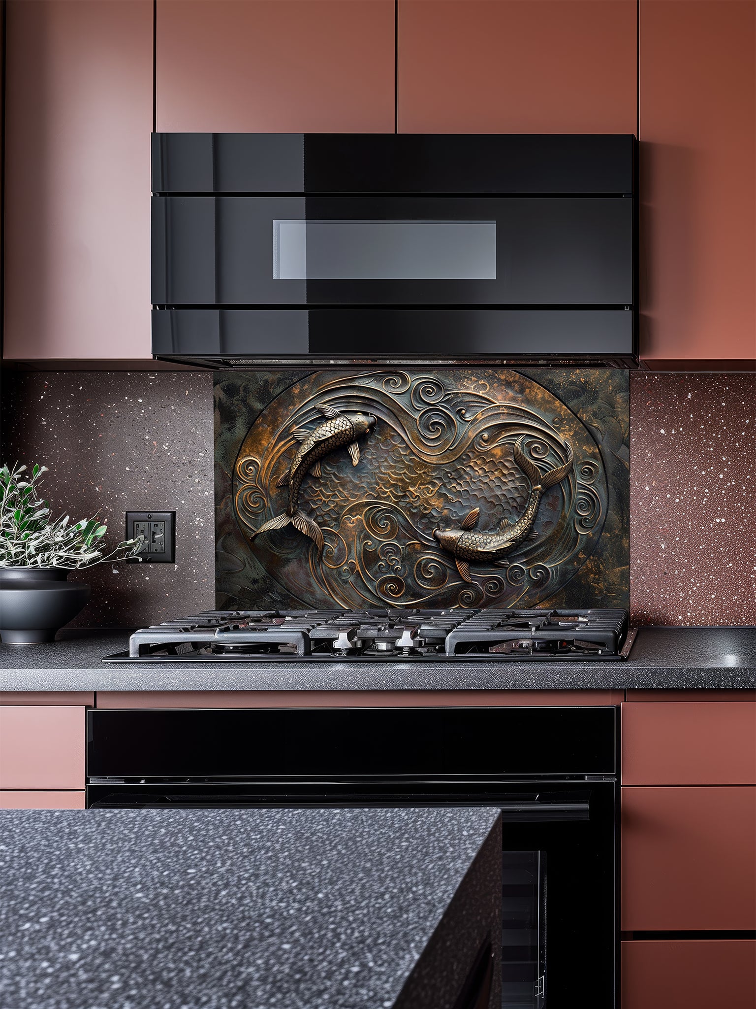 Tempered glass kitchen backsplash featuring a highly realistic 3D faux metal design of two Koi fish swimming in a circular Yin-Yang pattern among swirling waves in antique bronze and dark oxidized tones, installed behind a modern stainless steel stove.