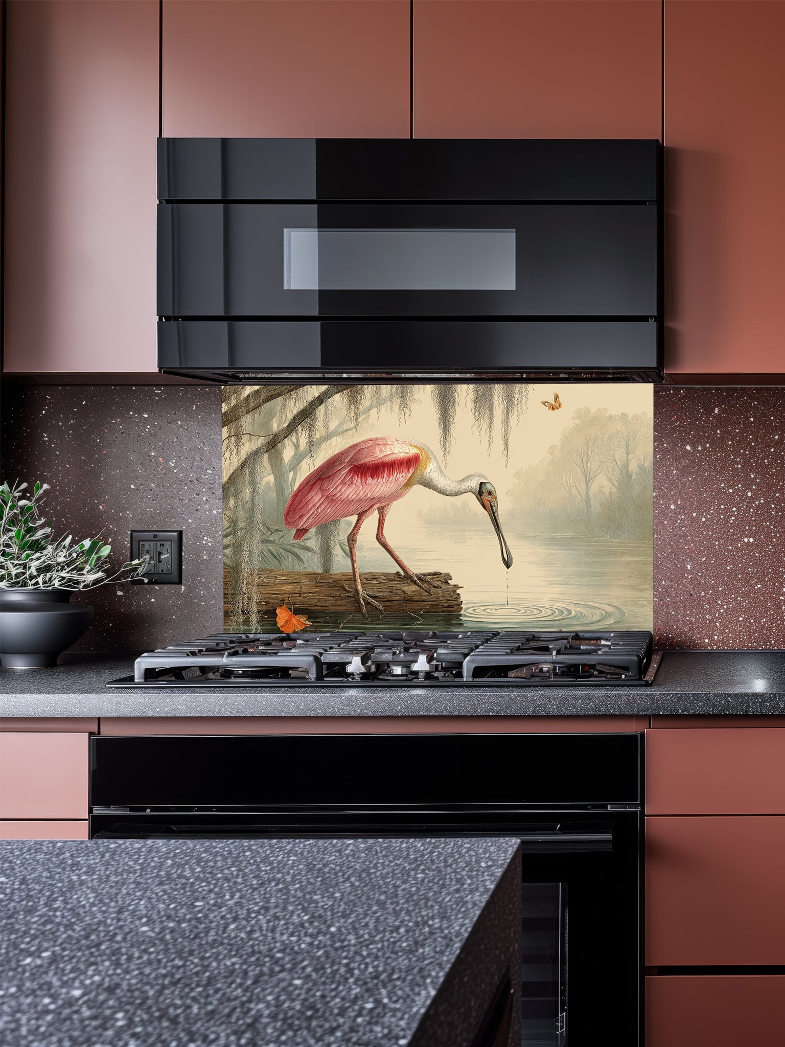 Tempered glass kitchen backsplash featuring a highly realistic illusion of a vintage Audubon-style naturalist illustration showing a beautiful pink roseate spoonbill bird wading in a swamp with weeping Spanish moss against an aged parchment background, installed behind a modern black stove.