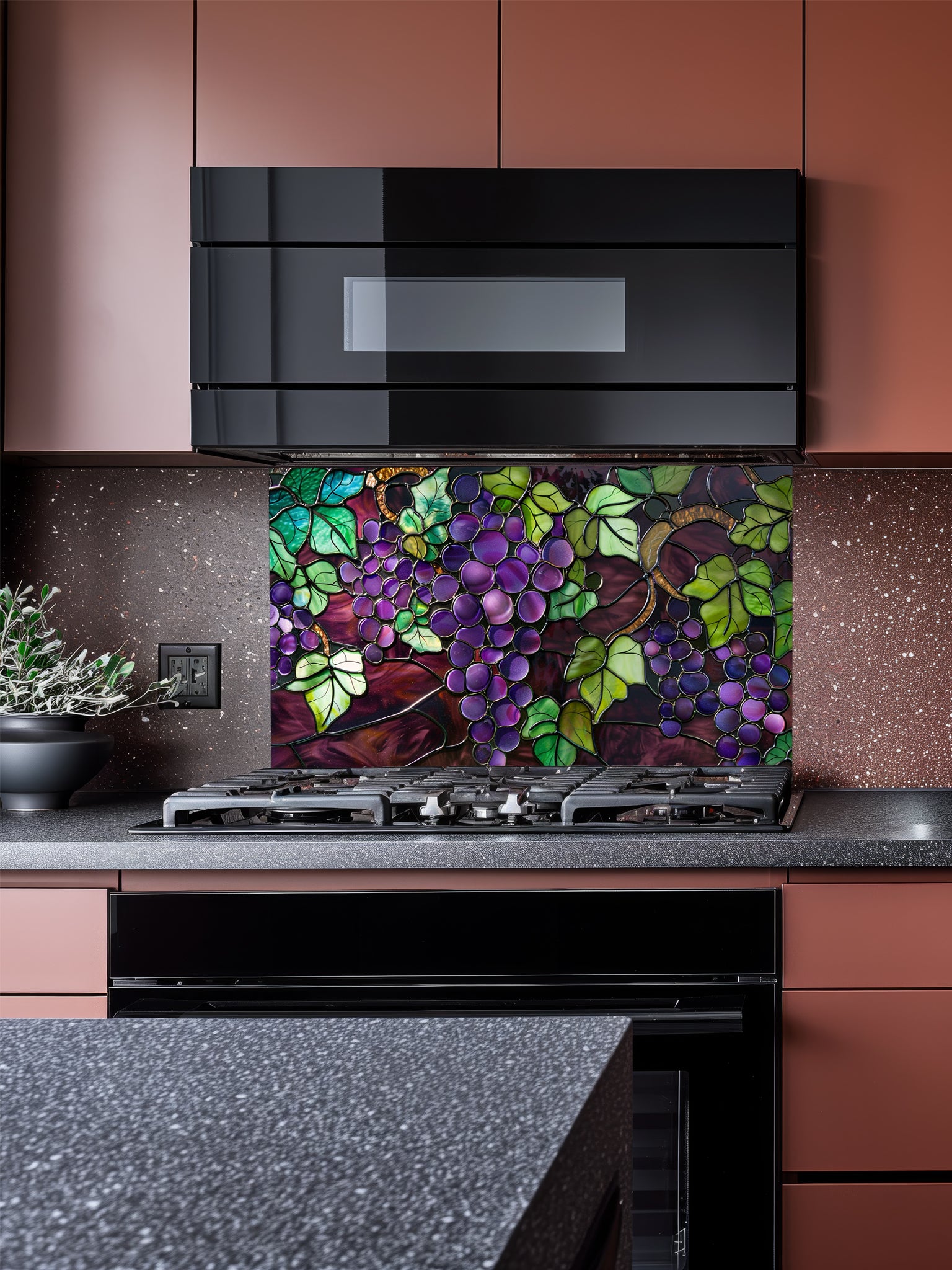 Stained glass style purple grapes and green vine leaves, UV printed on a smooth tempered glass kitchen backsplash, installed behind a modern stove.