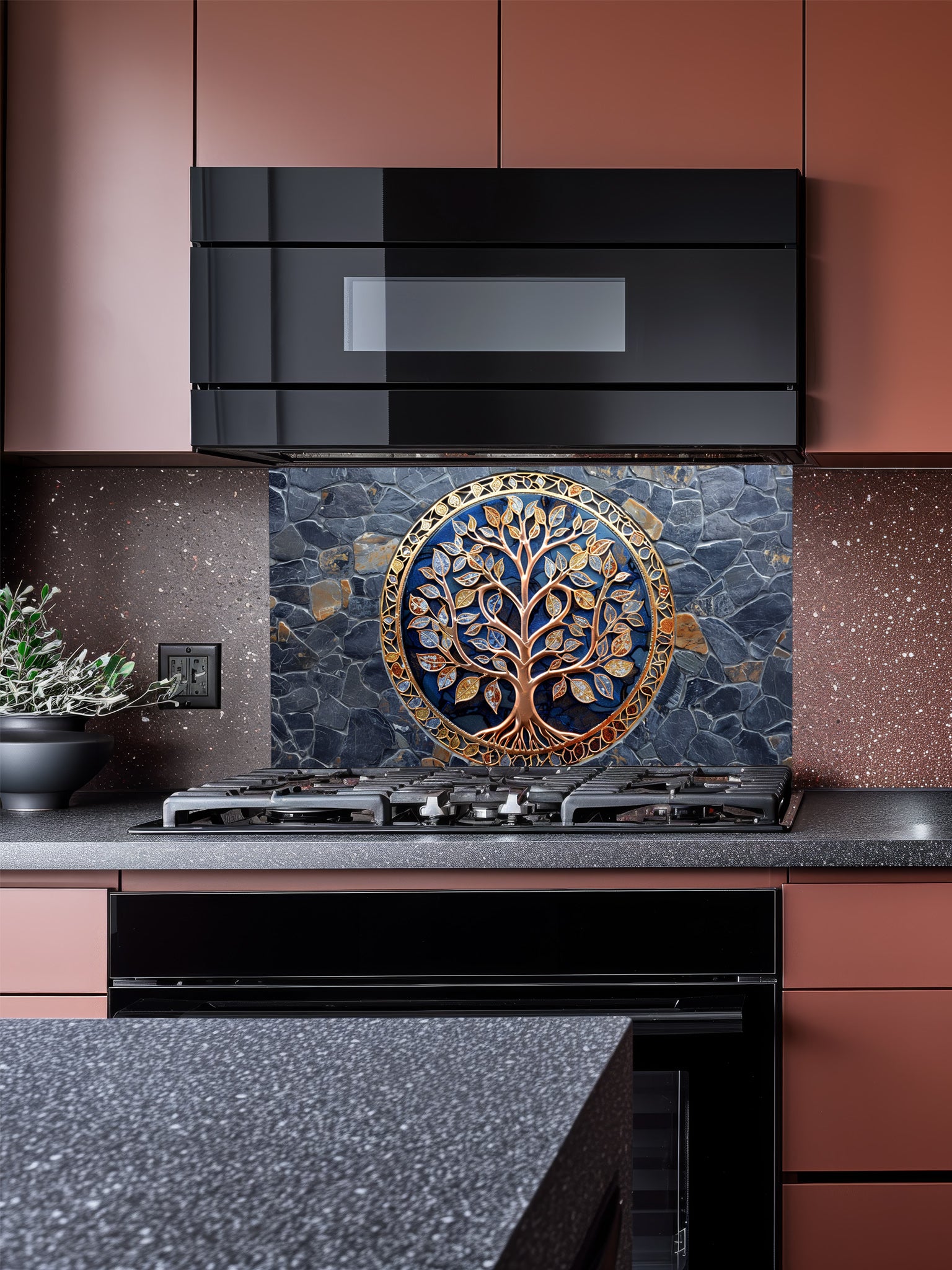 Metallic gold Tree of Life design on dark slate stone texture UV printed on tempered glass kitchen backsplash, installed behind a modern stove.
