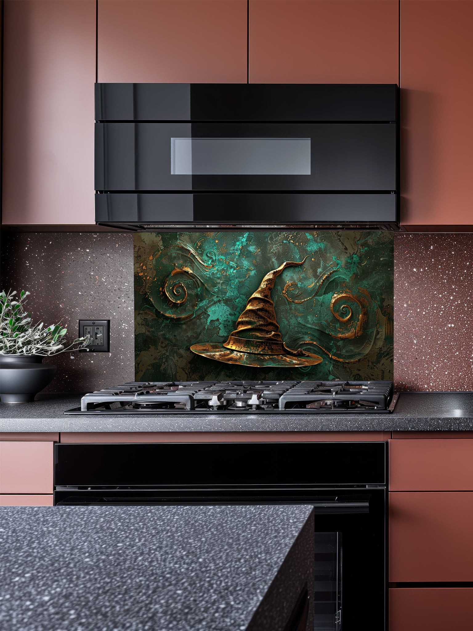 Tempered glass kitchen backsplash featuring a highly realistic 3D illusion of an antique gold sculpted witch or wizard hat surrounded by magical swirling patterns against a textured deep teal background, installed behind a modern black stove.