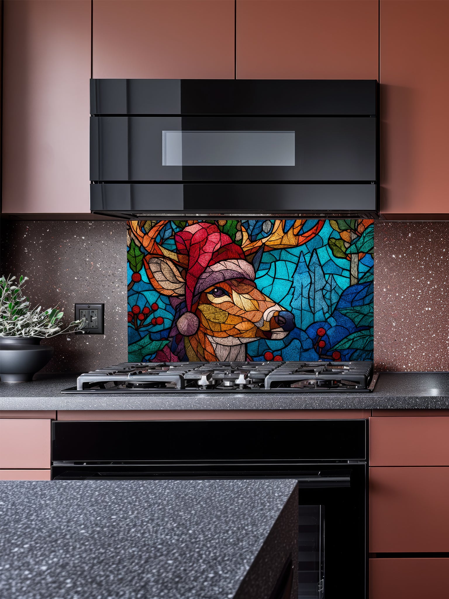 Tempered glass kitchen backsplash featuring a highly realistic 3D illusion of stained glass and mosaic art showing a festive reindeer wearing a red Santa hat in a frosty blue winter forest with holly berries, installed behind a modern black stove.