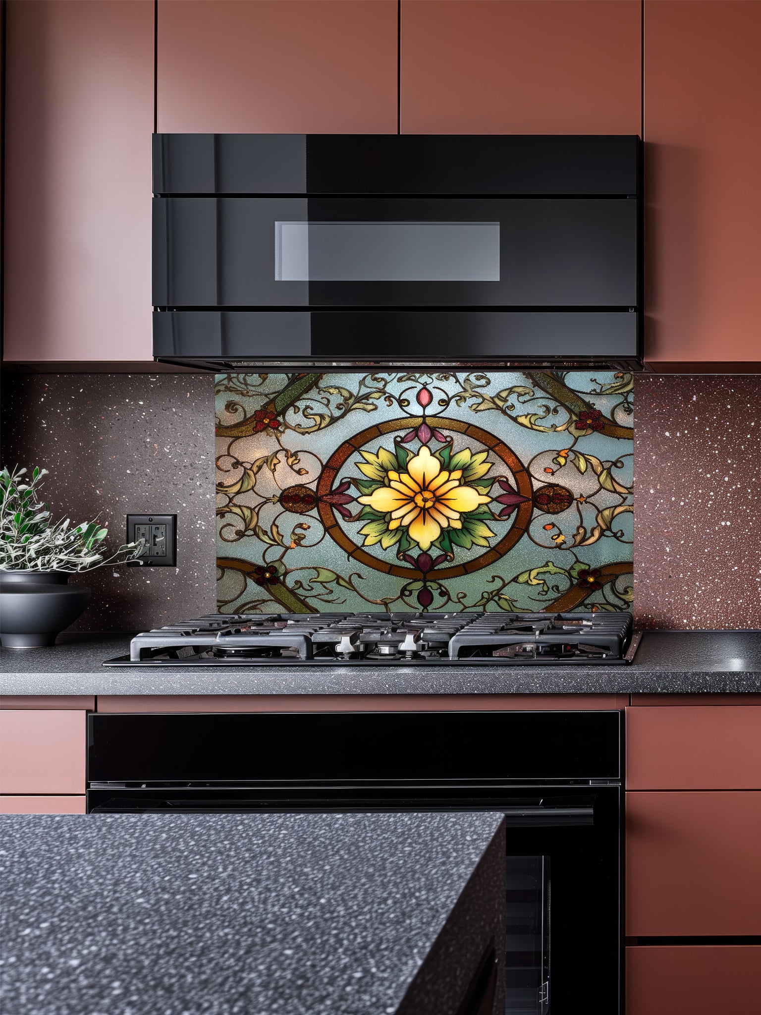Tempered glass kitchen backsplash featuring a highly realistic 3D illusion of vintage stained glass, showcasing a glowing yellow floral medallion surrounded by green vines and red accents against a frosted blue background, installed behind a modern stainless steel stove.