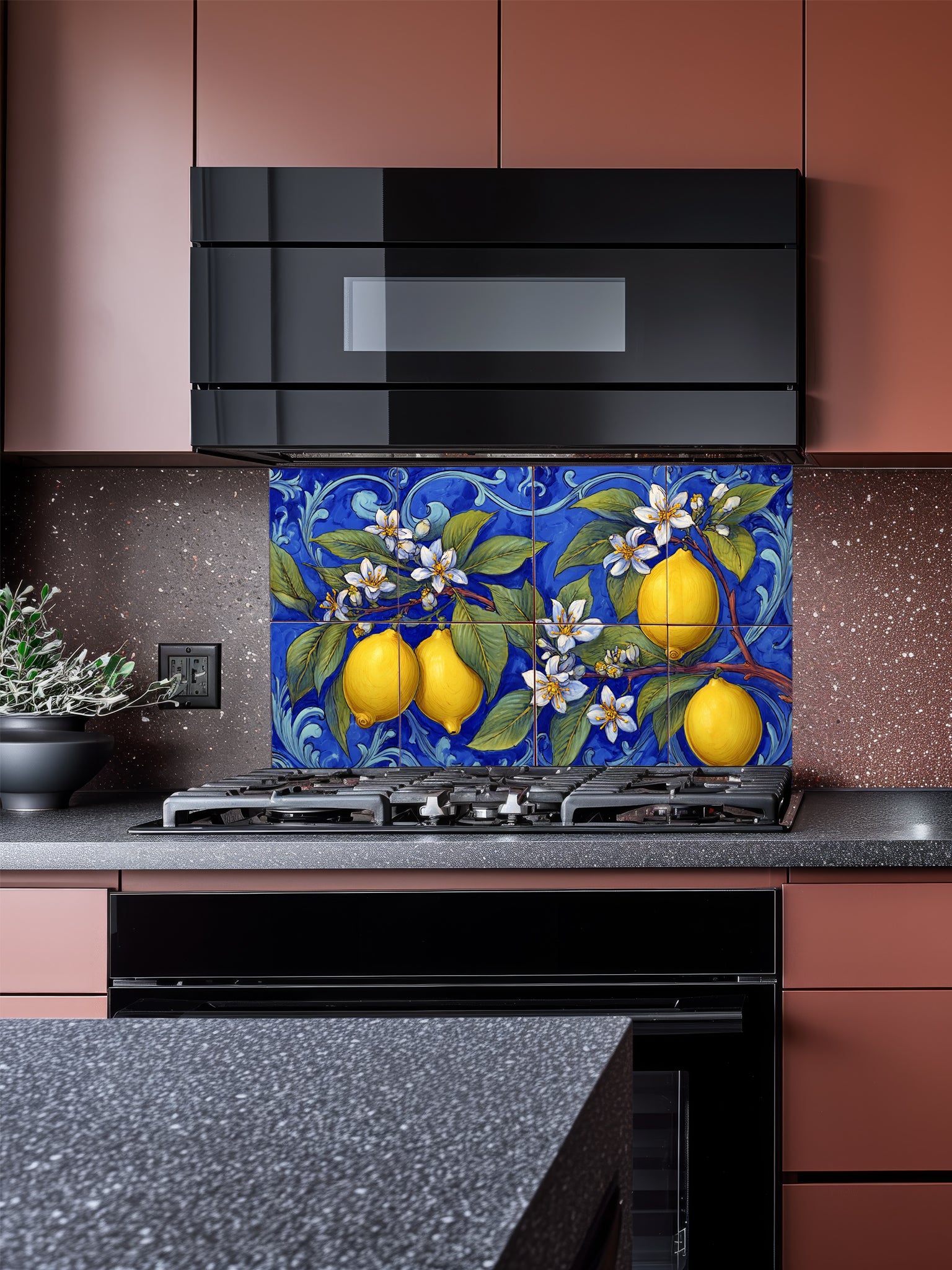 Tempered glass kitchen backsplash featuring a highly realistic illusion of traditional hand-painted Italian Majolica ceramic tiles, showcasing bright yellow lemons, white blossoms, and green leaves against a deep royal blue background with elegant scrollwork, installed behind a modern black stove.