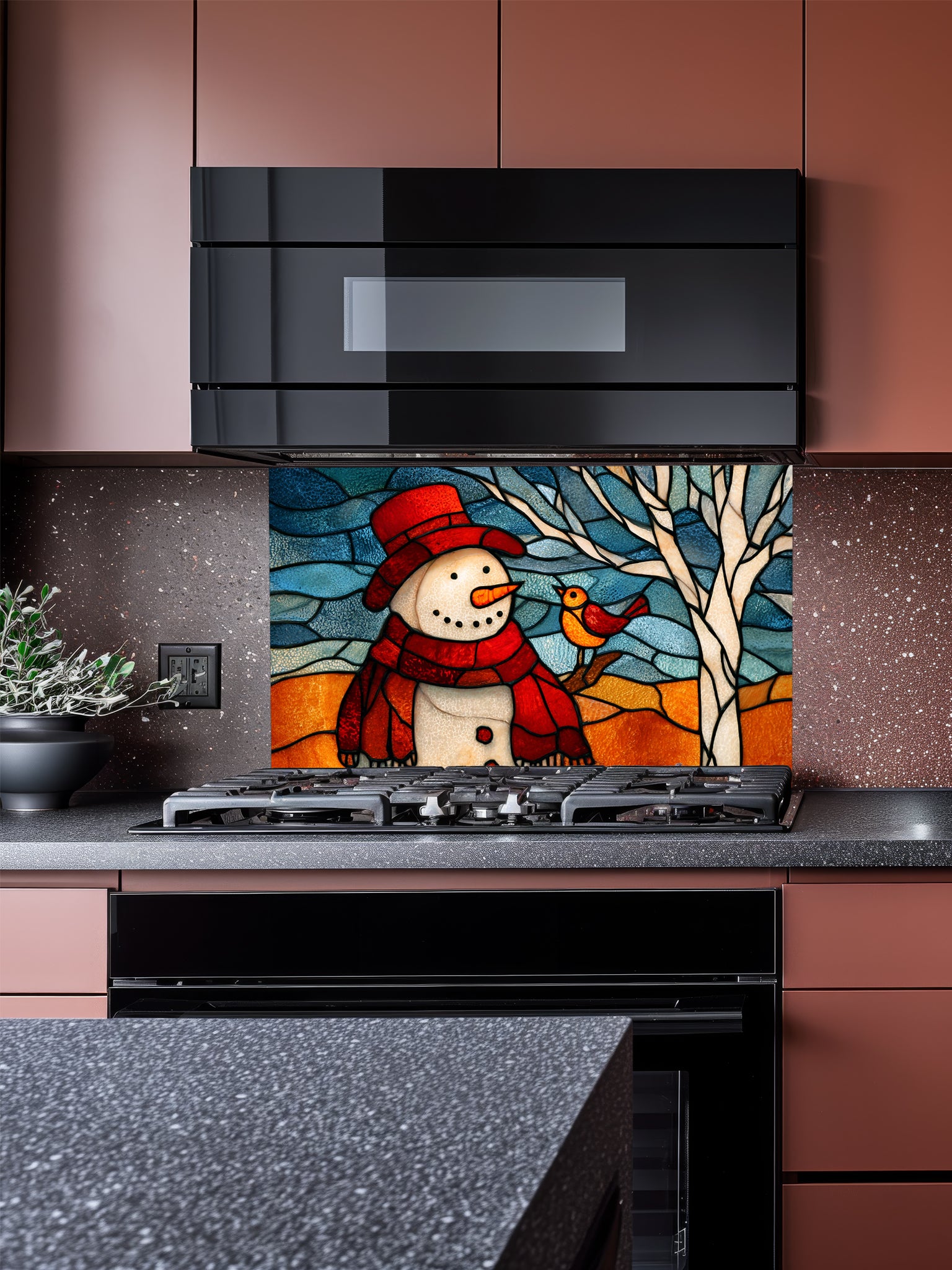 Tempered glass kitchen backsplash featuring a highly realistic 3D illusion of stained glass art showing a cheerful snowman in a red hat and a cute little bird perched on a winter tree against a frosty blue and amber background, installed behind a modern black stove.
