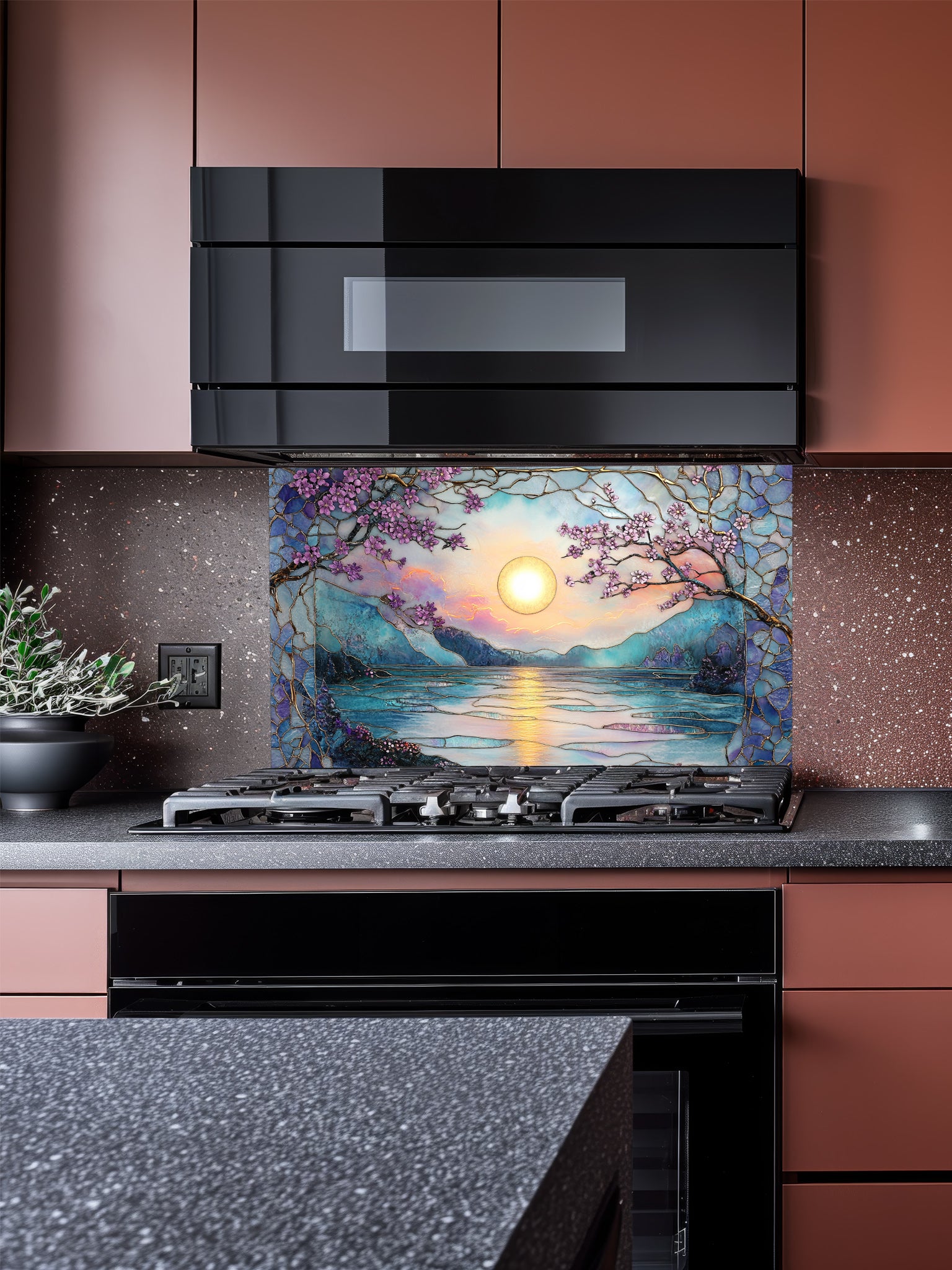 Stained glass style serene sunset over a lake with pink cherry blossoms and mountains, UV printed on a smooth tempered glass kitchen backsplash, installed behind a modern stove.