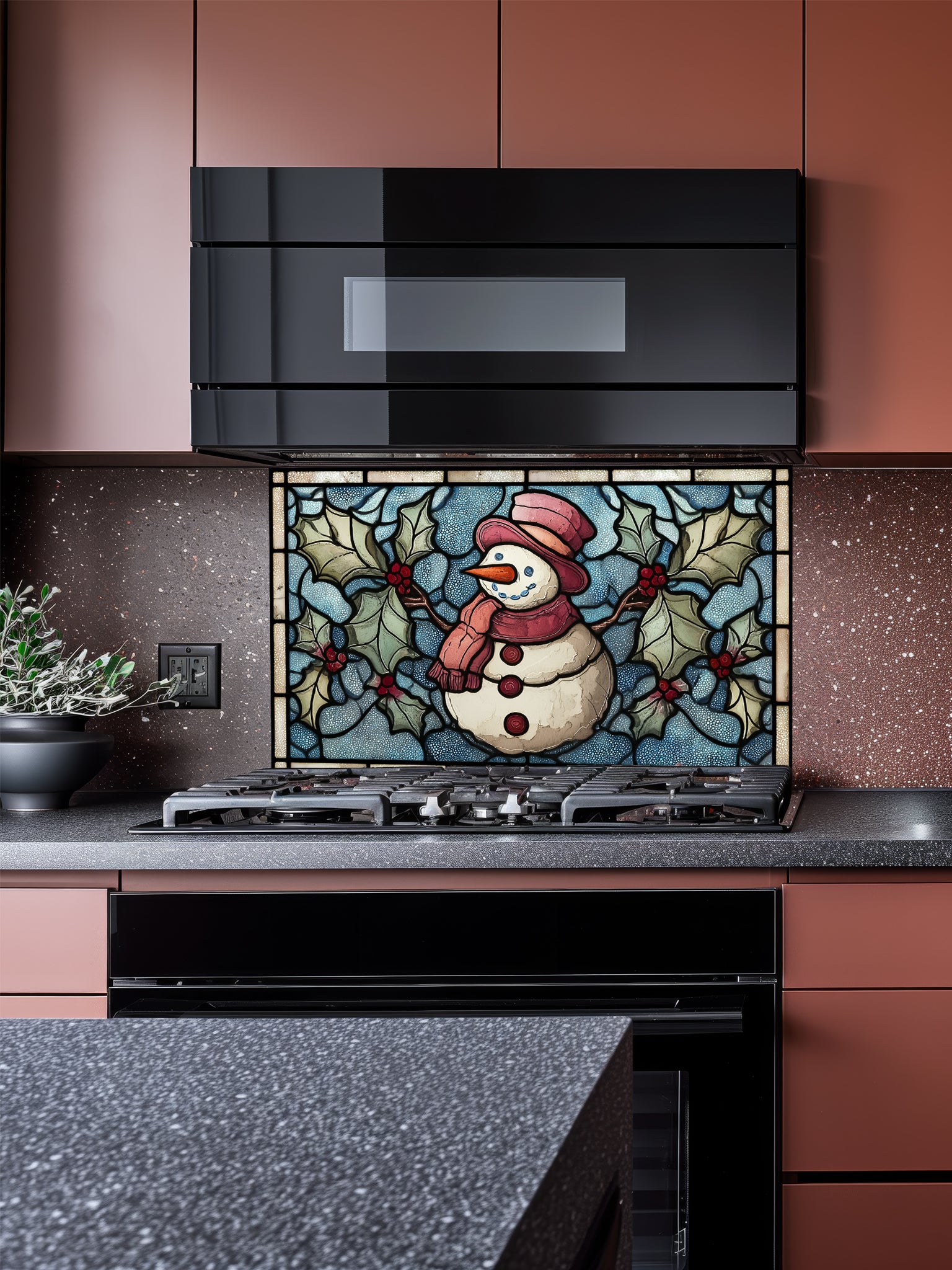 Tempered glass kitchen backsplash featuring a highly realistic 3D illusion of stained glass art showing a cheerful snowman with a red hat and scarf surrounded by green winter holly and red berries against a frosted icy blue background, installed behind a modern black stove.