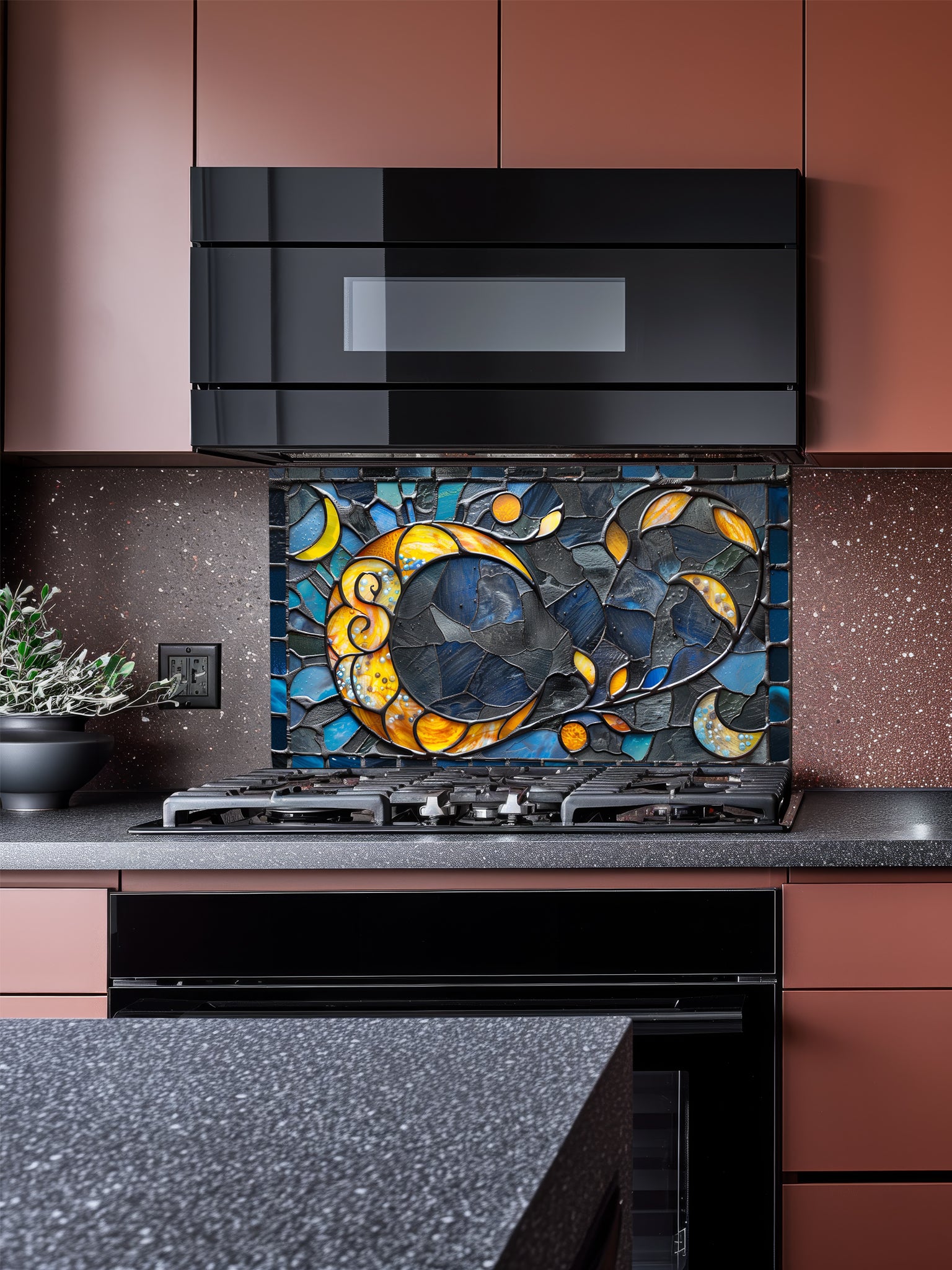 Tempered glass kitchen backsplash featuring a highly realistic 3D illusion of an abstract mosaic moon glowing in amber and gold against a swirling midnight blue and charcoal background, installed behind a modern black stove.