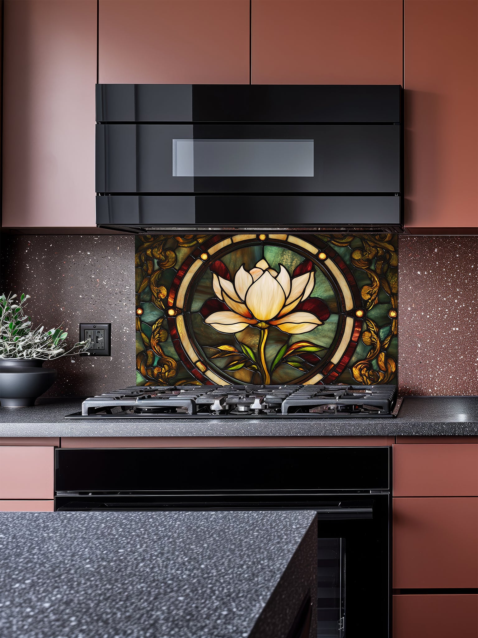 Tempered glass kitchen backsplash featuring a highly realistic faux stained glass design of a central white lotus flower surrounded by intricate Art Nouveau vines in rich emerald green and glowing amber tones, installed behind a modern stainless steel stove.