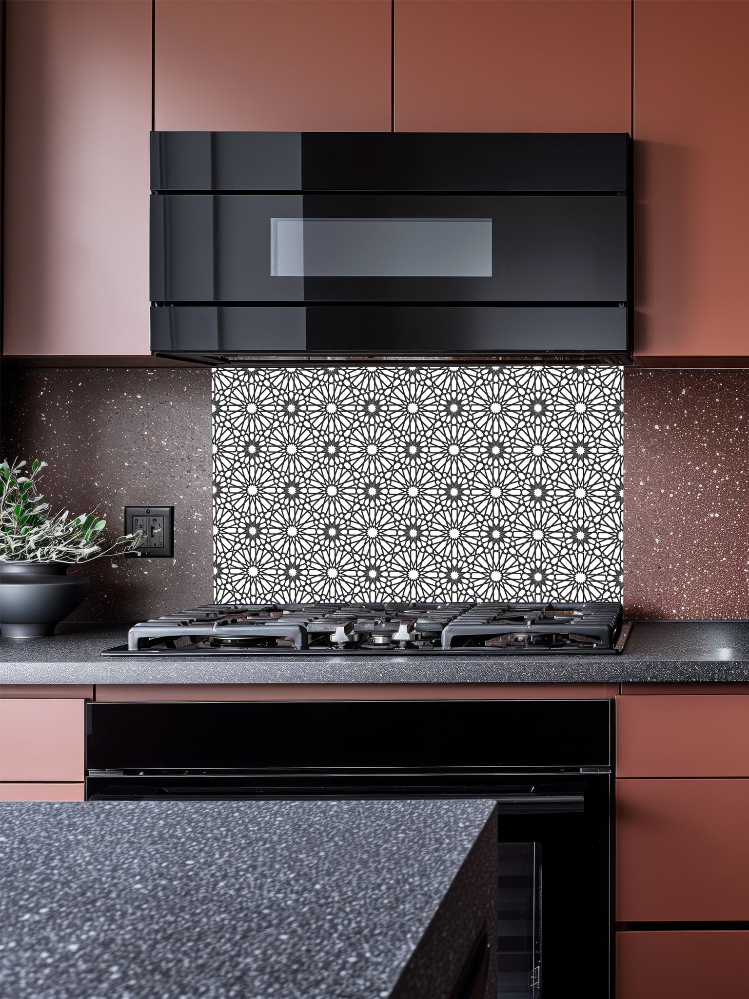 Modern kitchen with black range hood and decorative backsplash