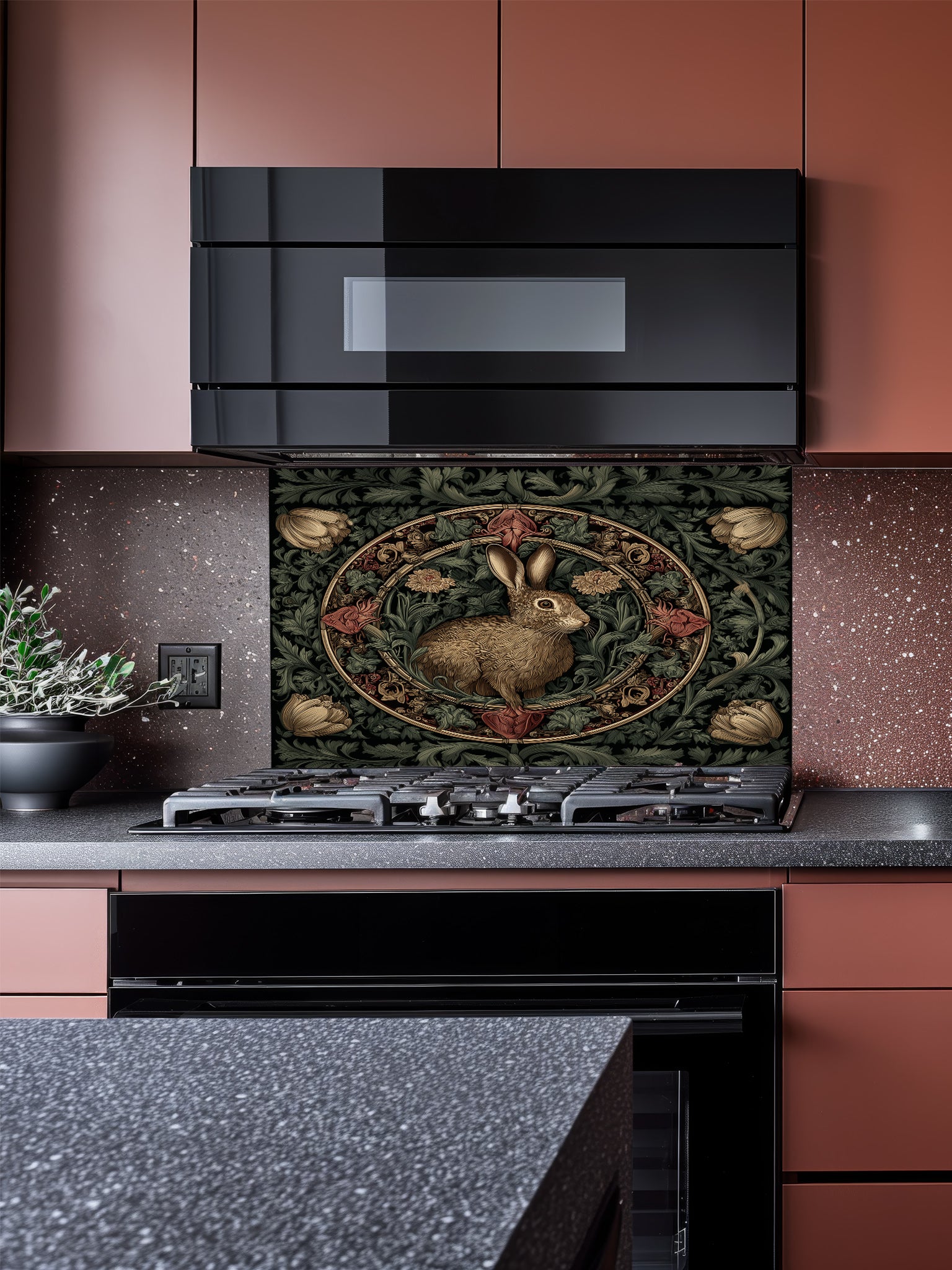 Tempered glass kitchen backsplash featuring a vintage-style dark botanical design with an ornate circular floral frame enclosing a classic illustration of a brown woodland hare, installed behind a modern stainless steel stove.