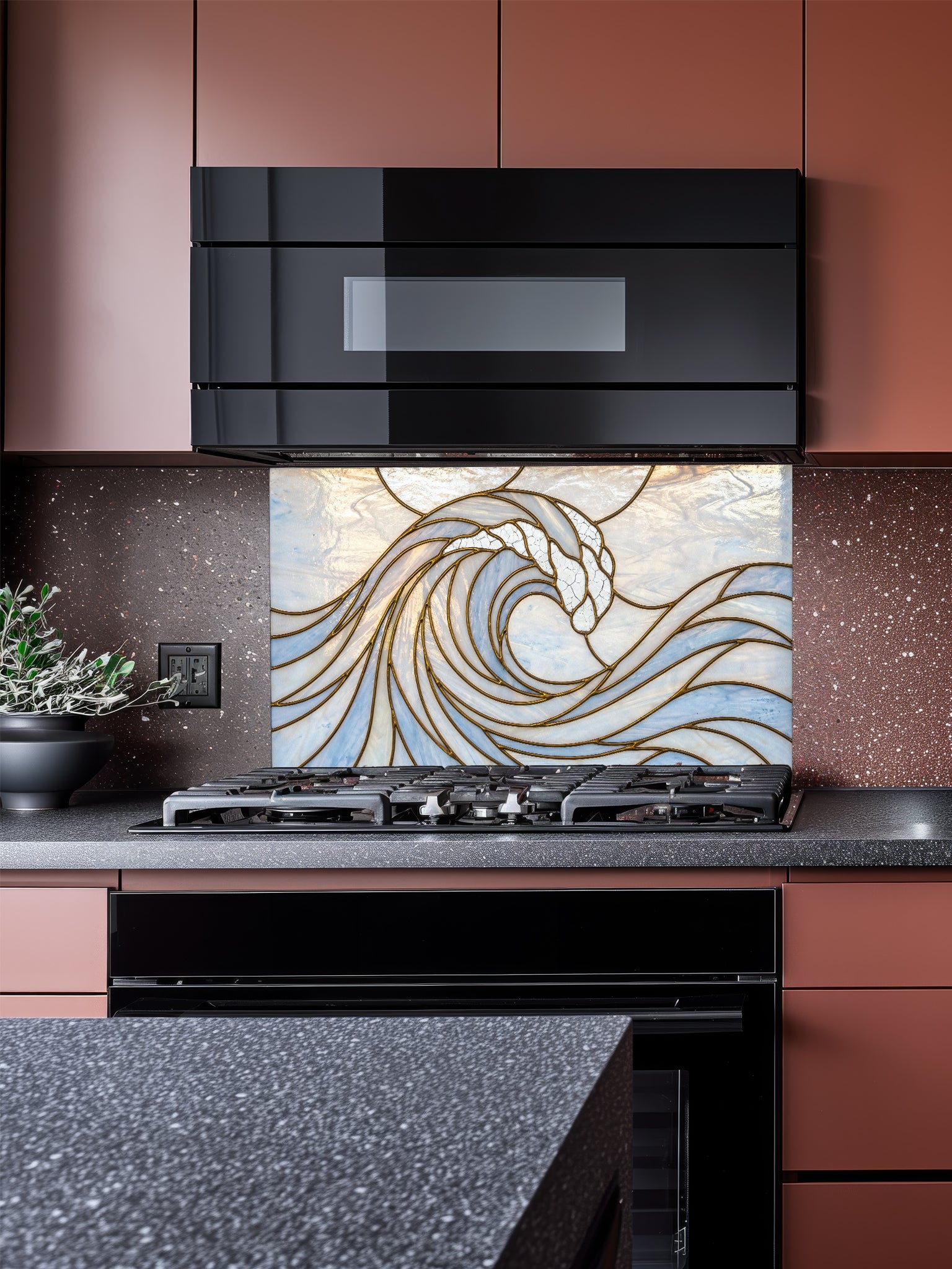Stained glass style ocean wave design UV printed on tempered glass kitchen backsplash, installed behind a modern stove.