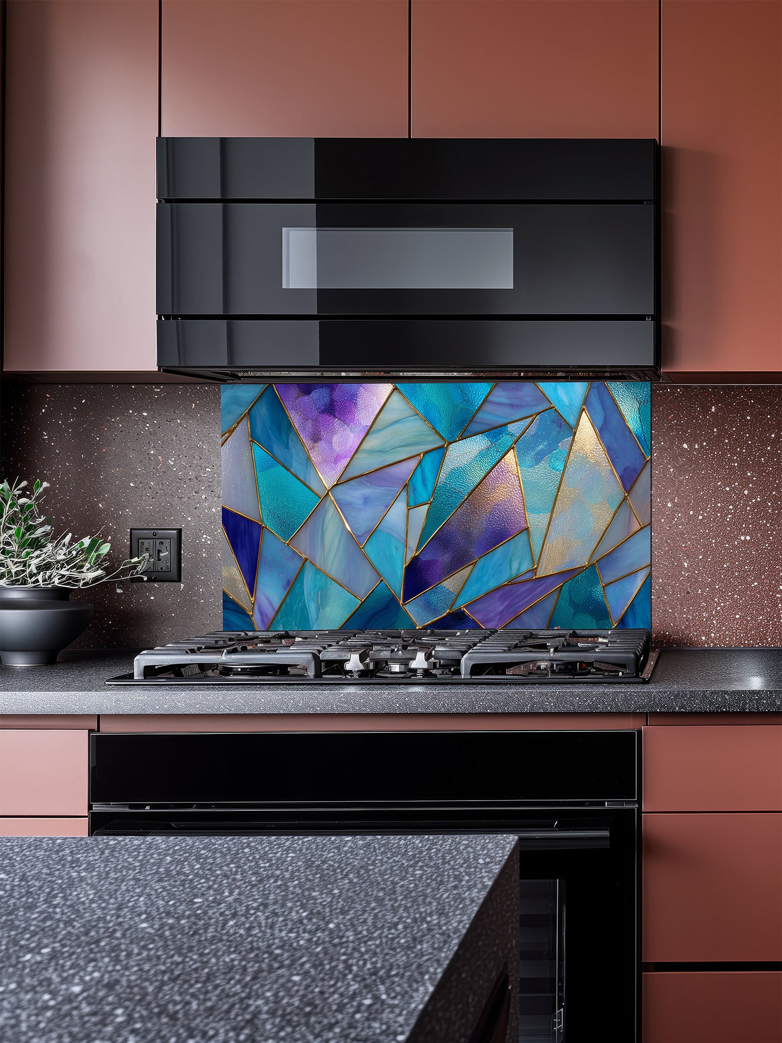 Tempered glass kitchen backsplash featuring a vibrant geometric stained glass effect with blue, teal, and purple shards separated by gold lines, installed behind a modern stainless steel stove.