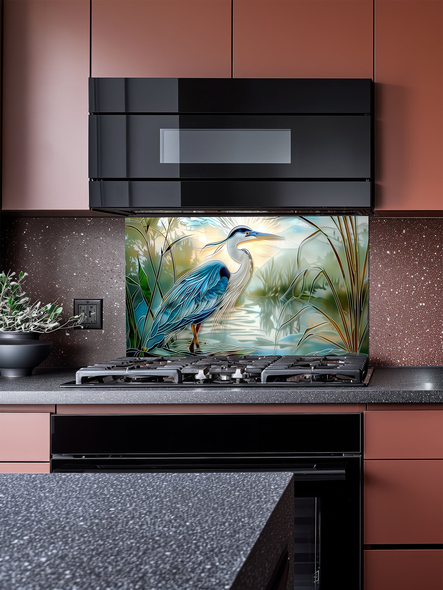 Tempered glass kitchen backsplash featuring a bright faux stained glass design of a majestic blue heron standing in a wetland, with bright sun rays radiating like a halo from behind its head, installed behind a modern stainless steel stove.