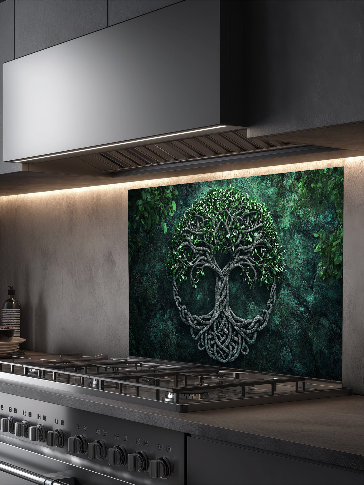 Tempered glass kitchen backsplash featuring a highly realistic 3D illusion of an ancient carved Celtic Tree of Life (Yggdrasil) with intricate knotwork roots and lush green leaves against a dark, moody forest green background, installed behind a modern black stove.
