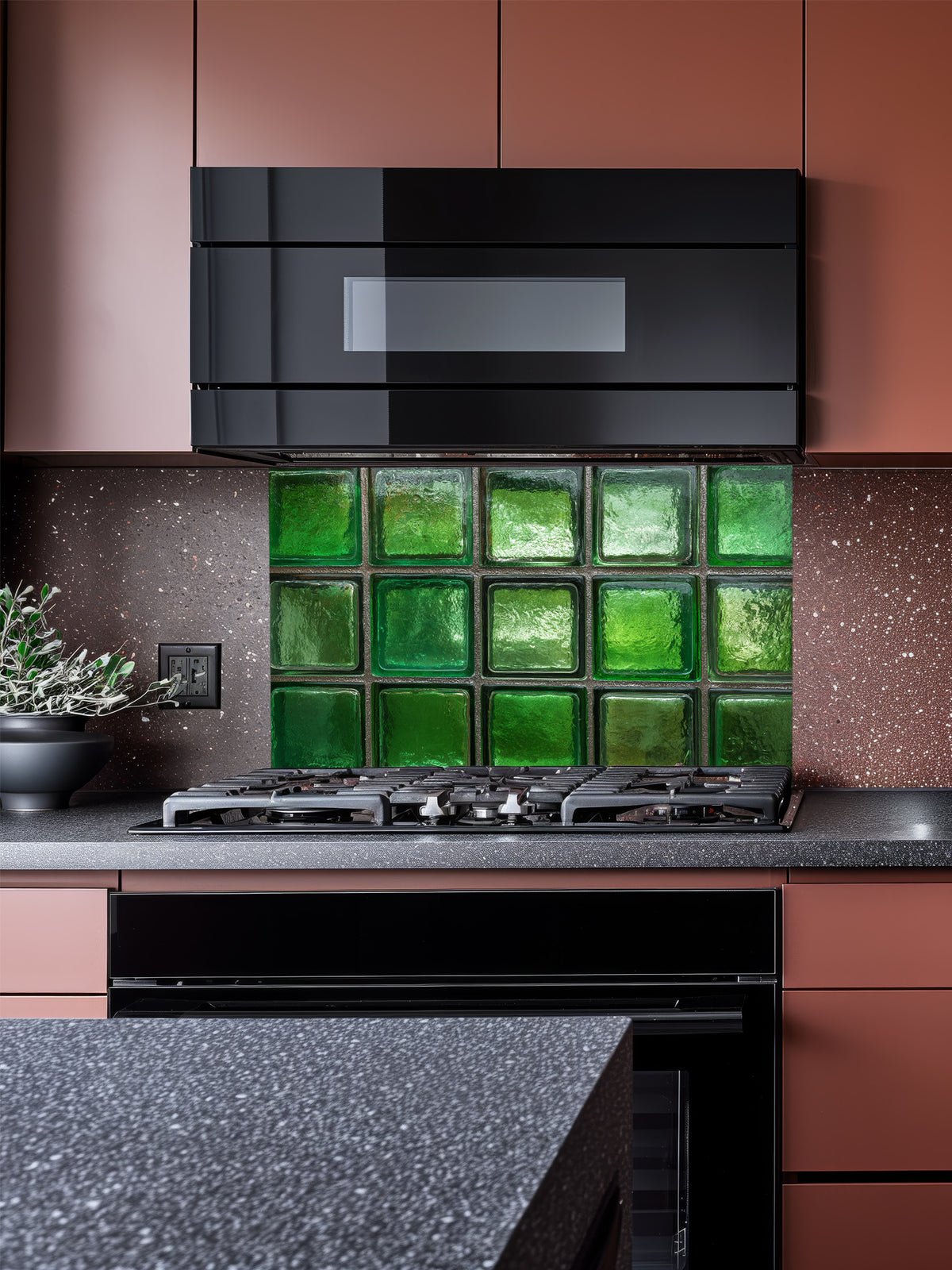 Faux green glass block 3D effect UV printed on a smooth tempered glass kitchen backsplash, installed behind a modern stove.