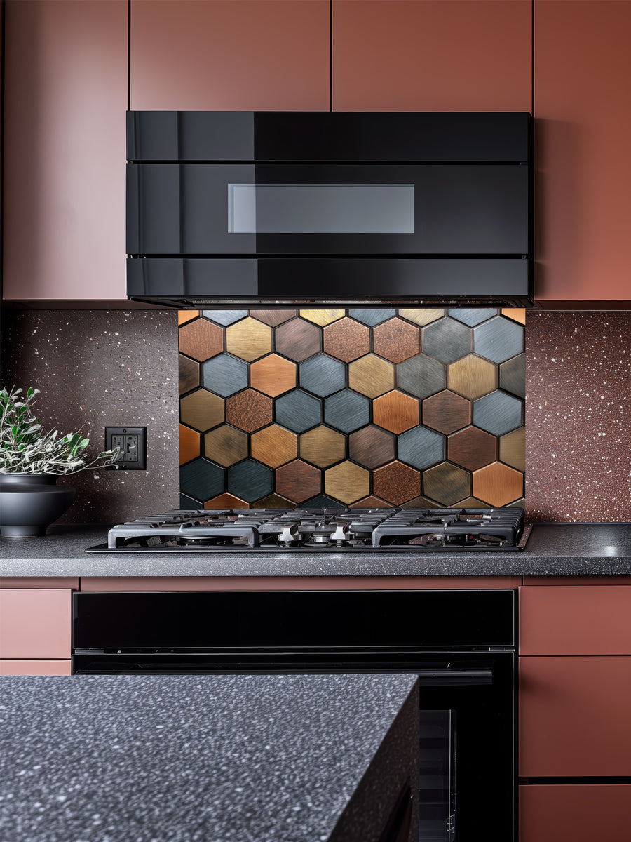 Faux 3D effect mixed metallic hexagon tiles in copper, bronze, and steel tones, UV printed on a smooth tempered glass kitchen backsplash, installed behind a modern stove.