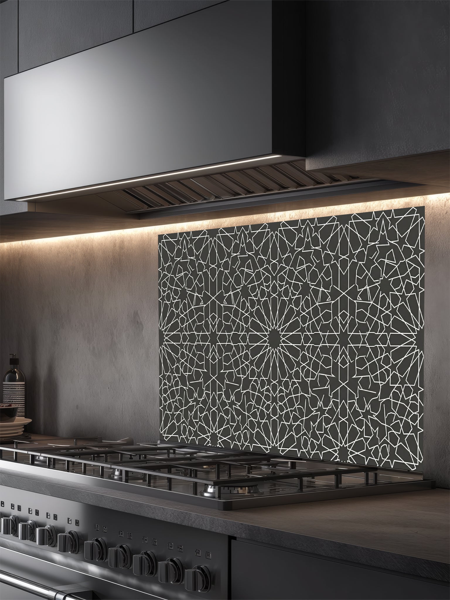 Modern kitchen with a decorative glass splashback behind a stove.
