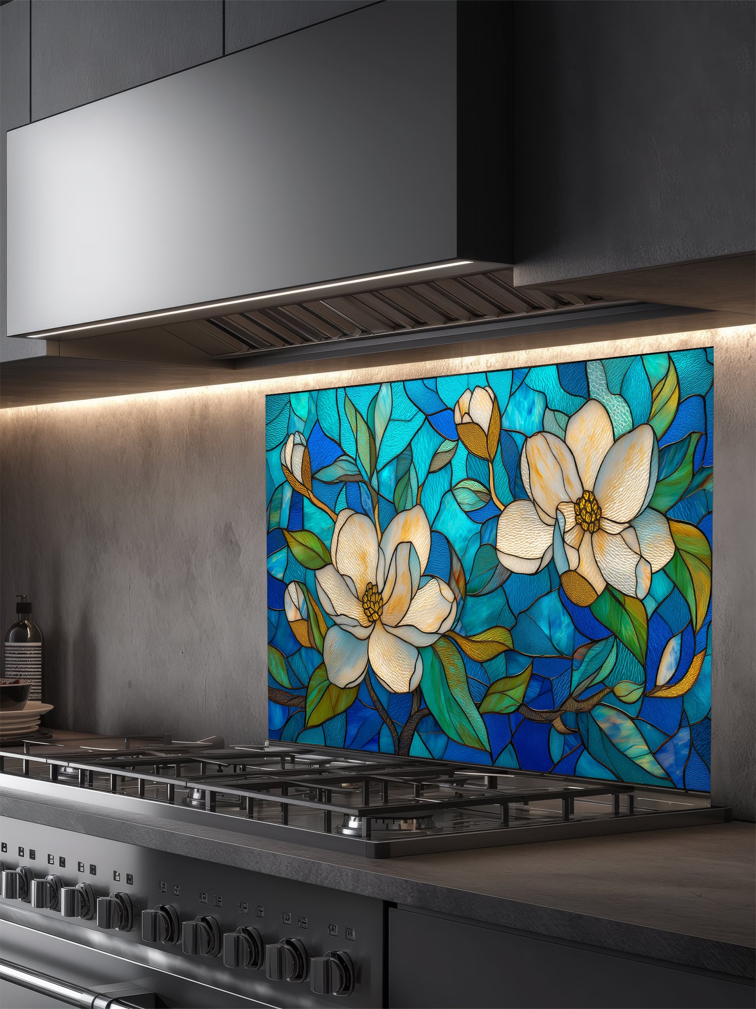 Stained glass style floral pattern featuring large white magnolia blossoms and green leaves against a vibrant blue and turquoise background, UV printed on a smooth tempered glass kitchen backsplash.
